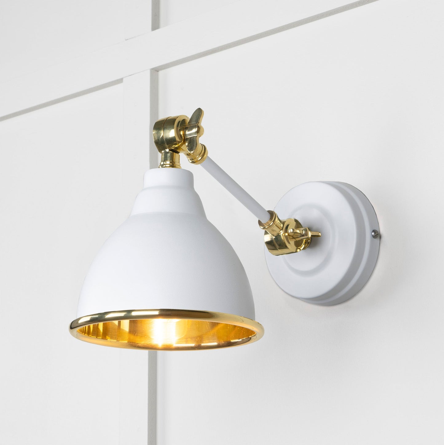 Smooth Brass Brindley Wall Light Flock, Front Side with light on.
