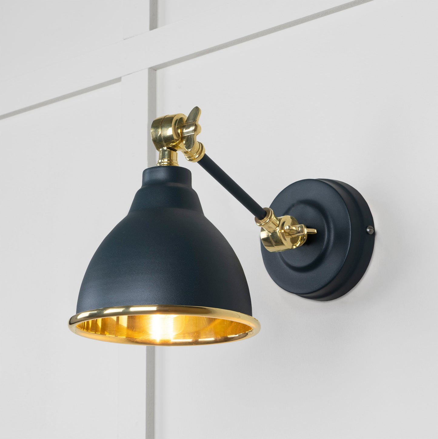 Smooth Brass Brindley Wall Light Soot, Front Side with light on.