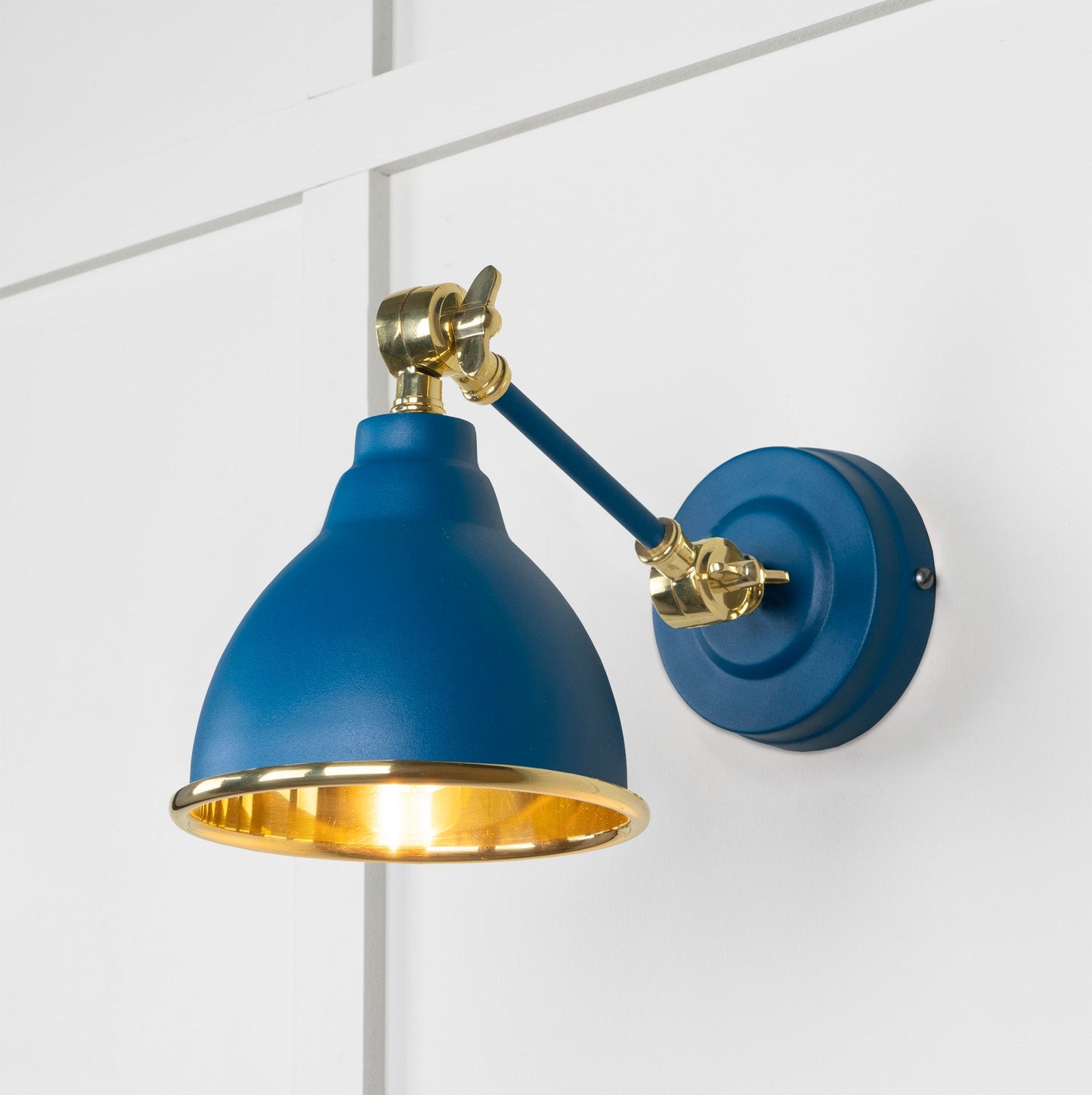 Smooth Brass Brindley Wall Light Upstream, Front Side with light on.