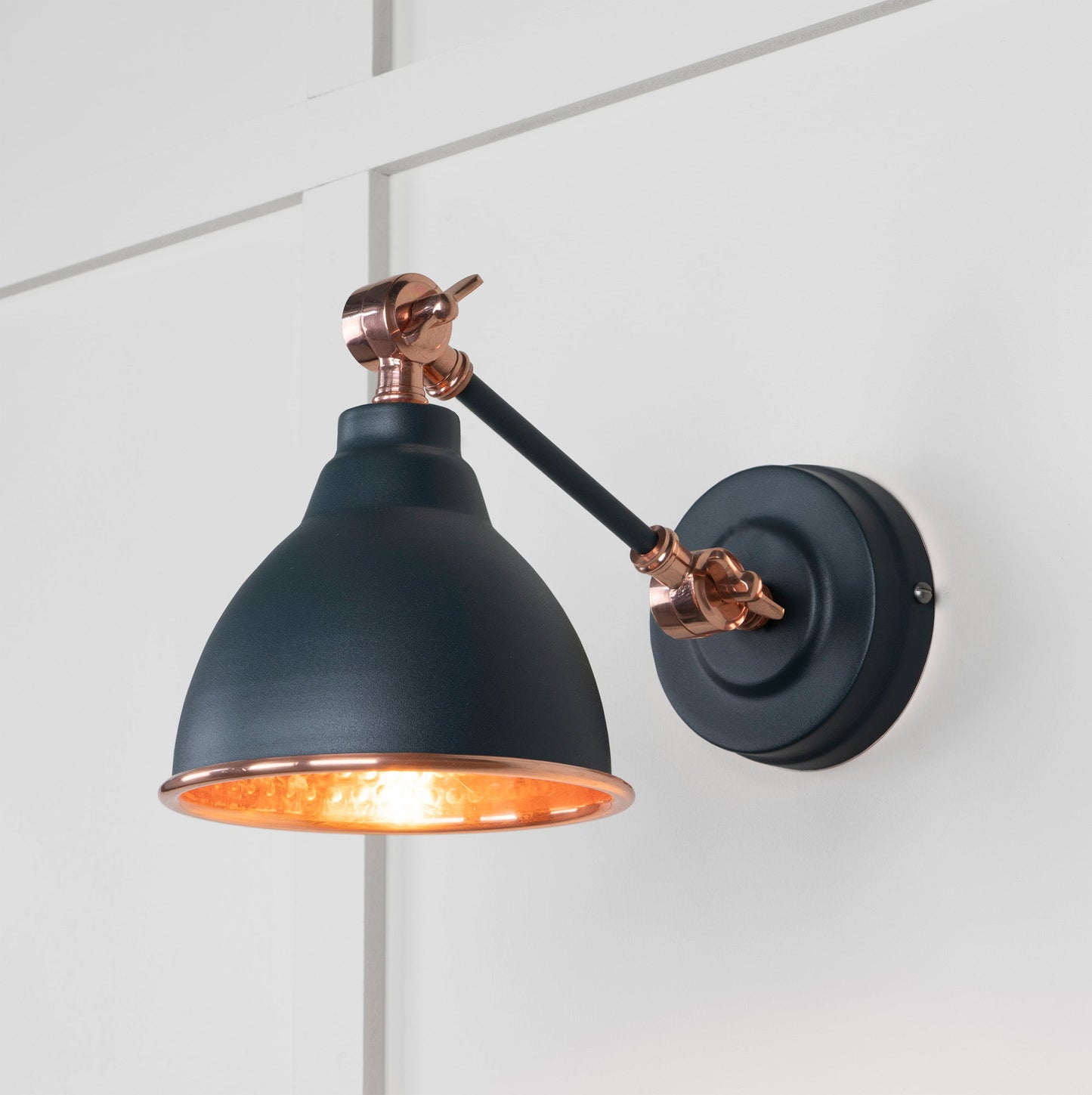 Hammered Copper Brindley Wall Light Soot, Front Side with light on.