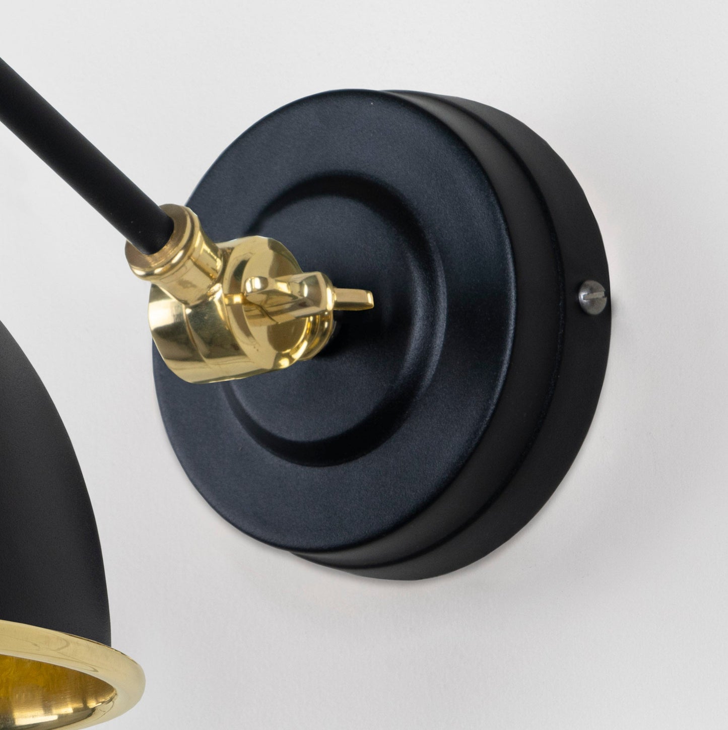 Hammered Brass Brindley Wall Light Elan Black, close up view of fitting and cable.