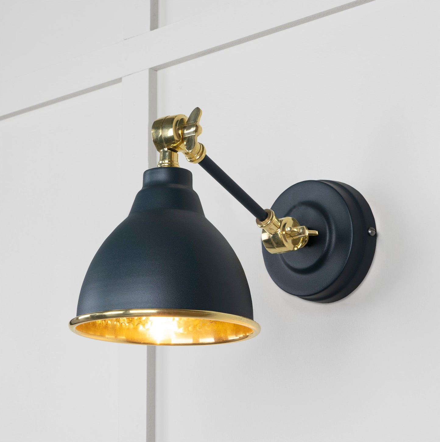 Hammered Brass Brindley Wall Light Soot, Front Side with light on.