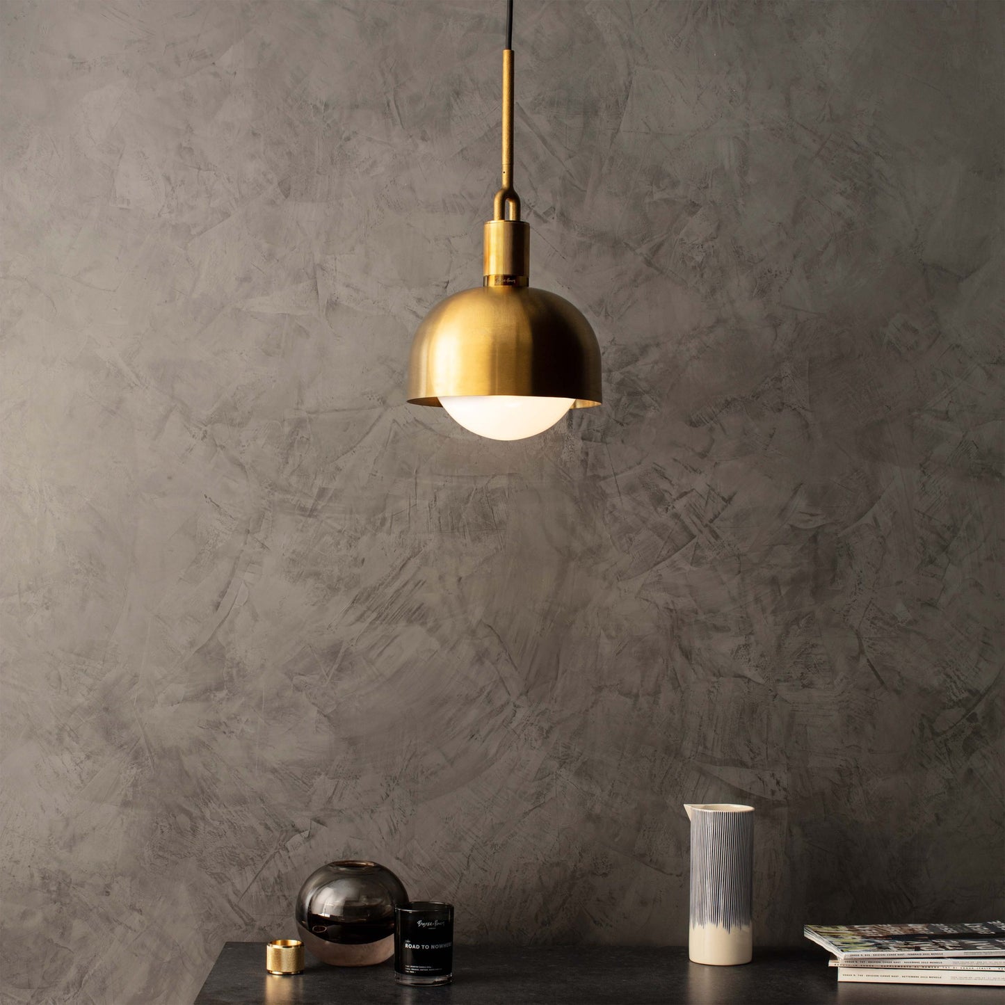 Forked Pendant Light / Shade / Globe / Opal / Medium brass, front view with background setting.