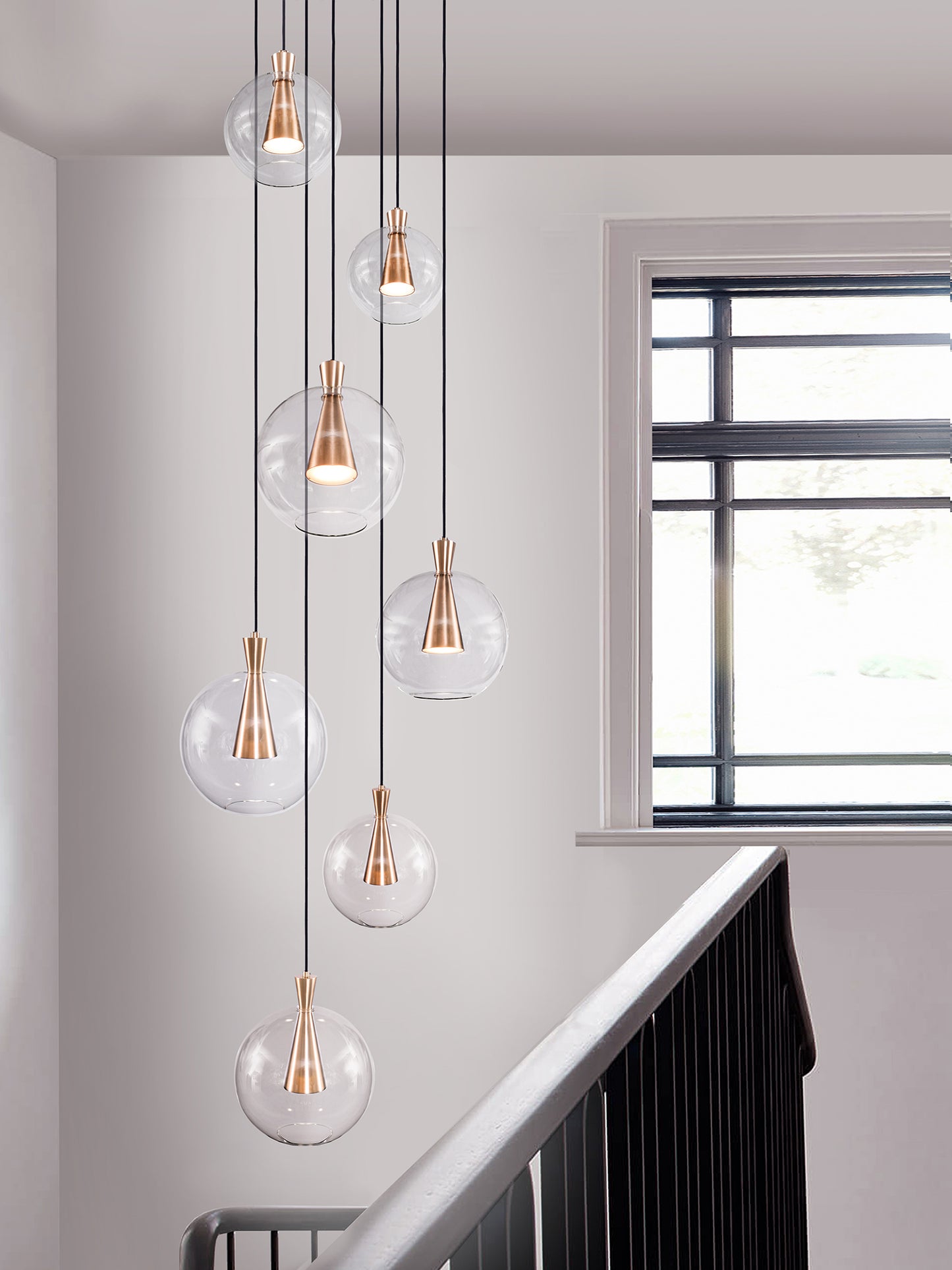 Cone 7 Shade Cluster Light, hanging from ceiling above stairs.