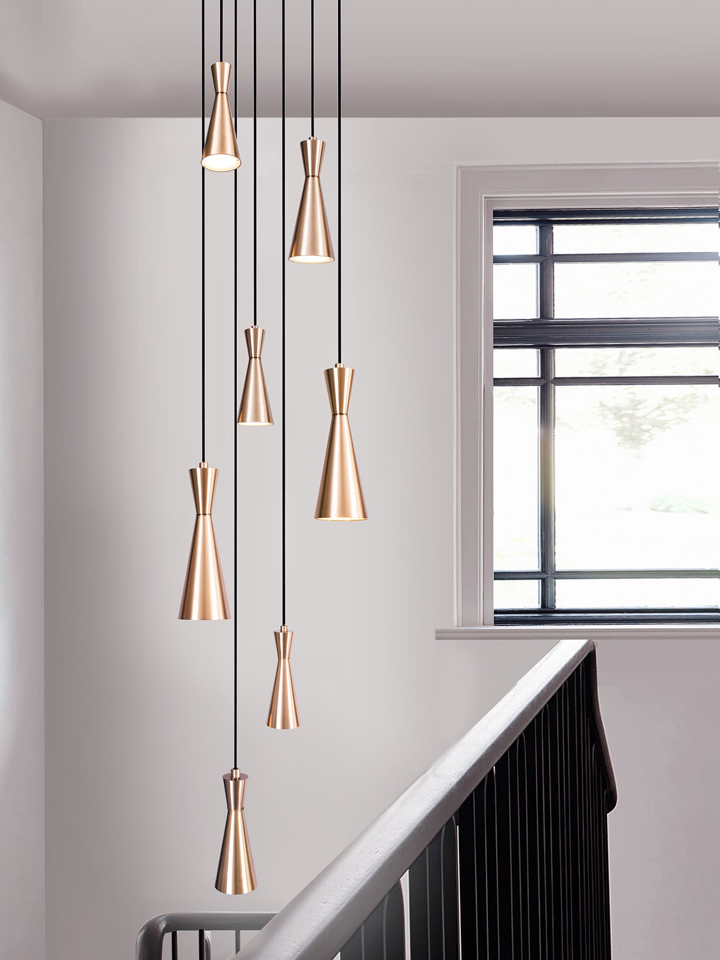 Cone 7 Cluster Light, hanging from ceiling above stairs.