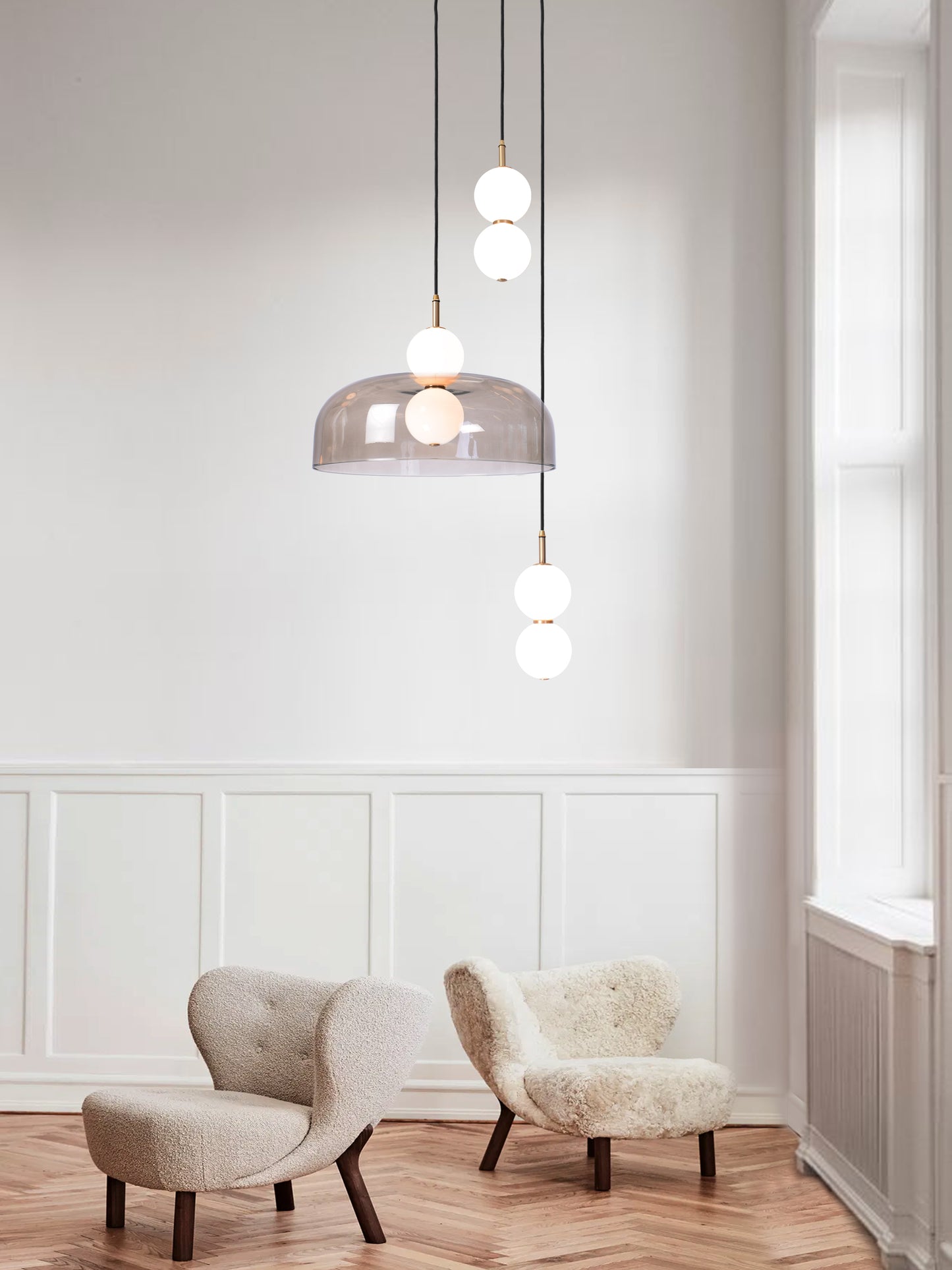 Echo 3 Shade Cluster Light, hanging from ceiling above chairs in setting.