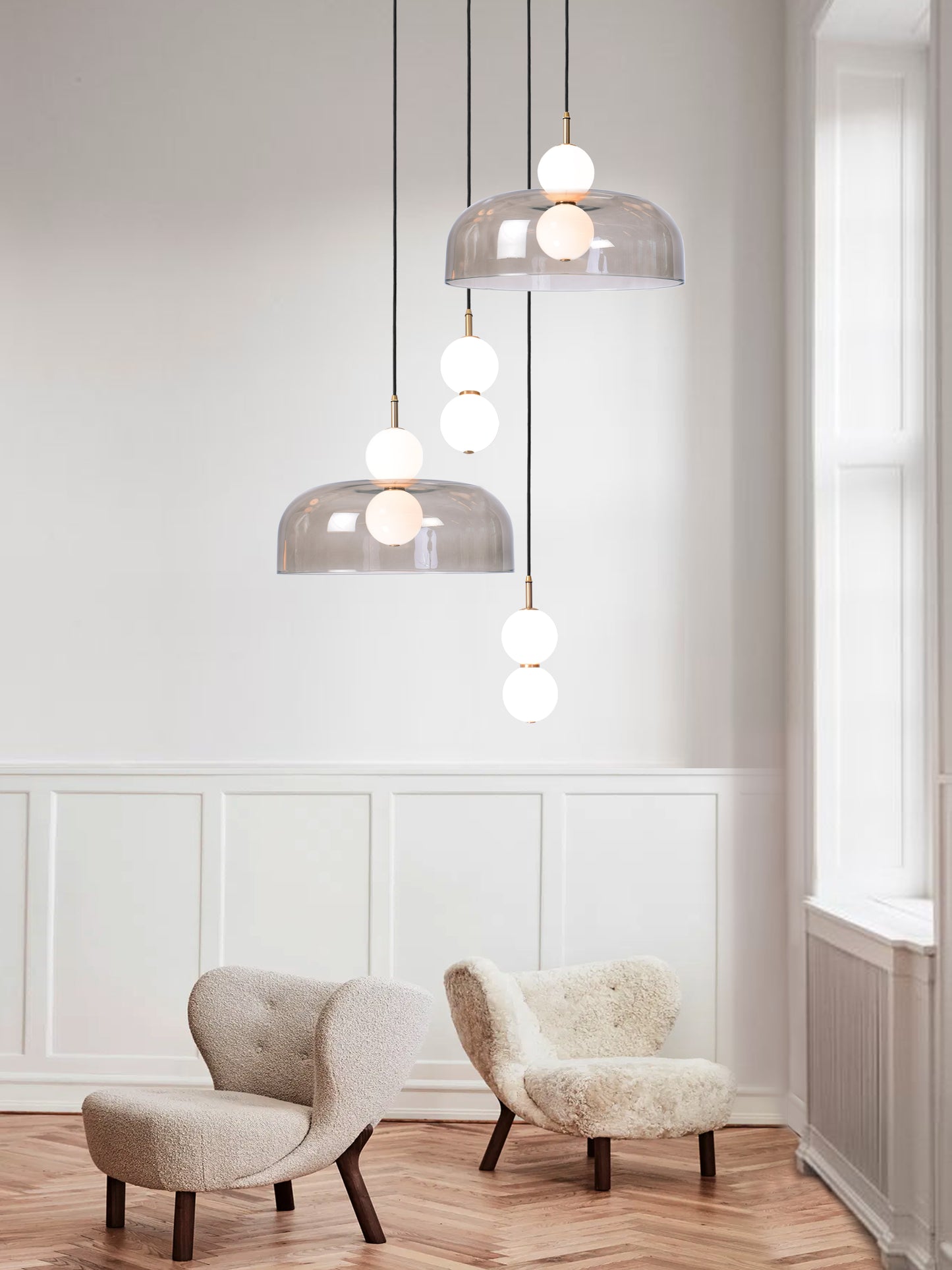 Echo 4 Shade Cluster Light, hanging from ceiling above chairs in setting.