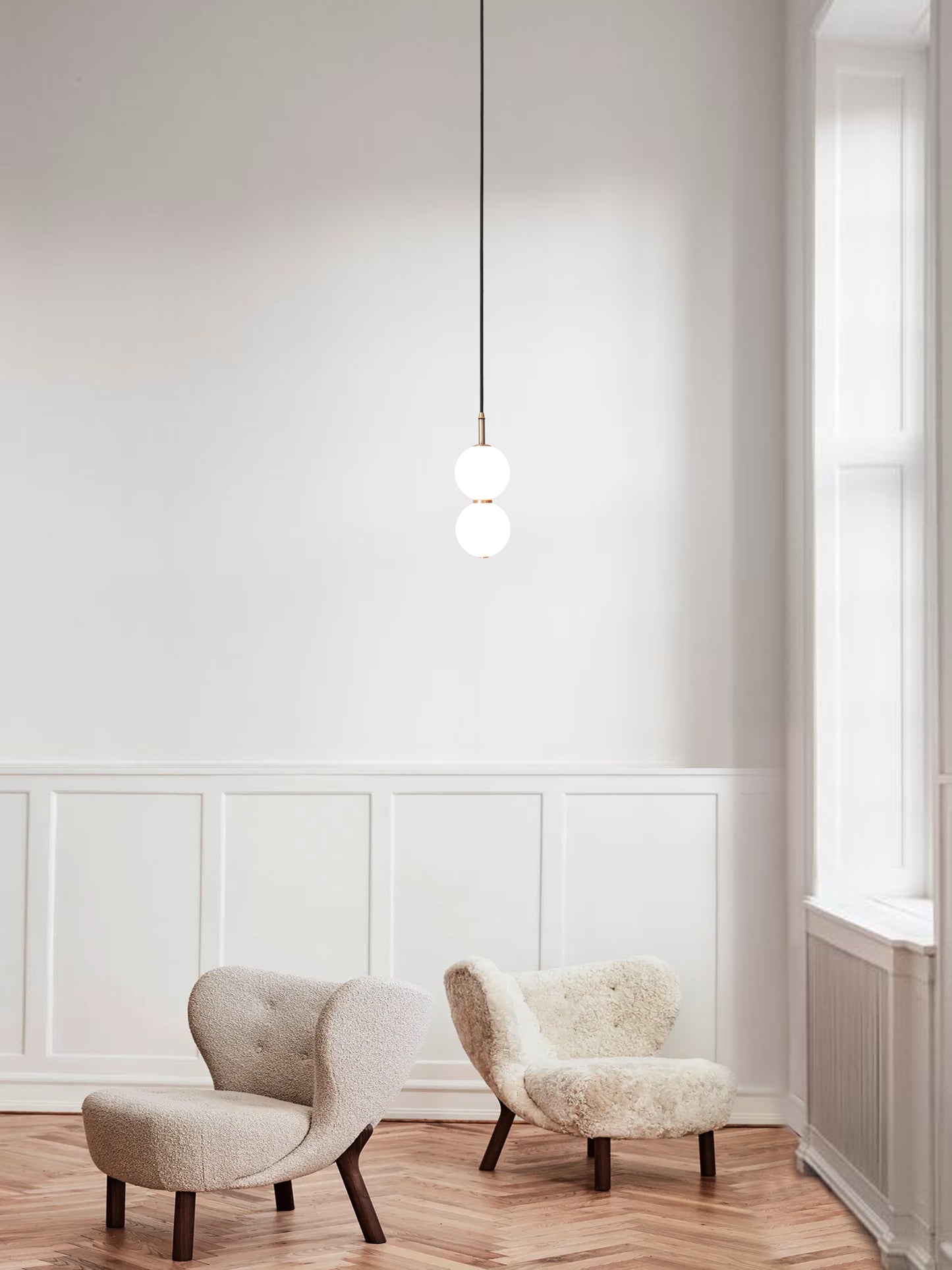 Echo Pendant Light. hanging from ceiling above chairs.