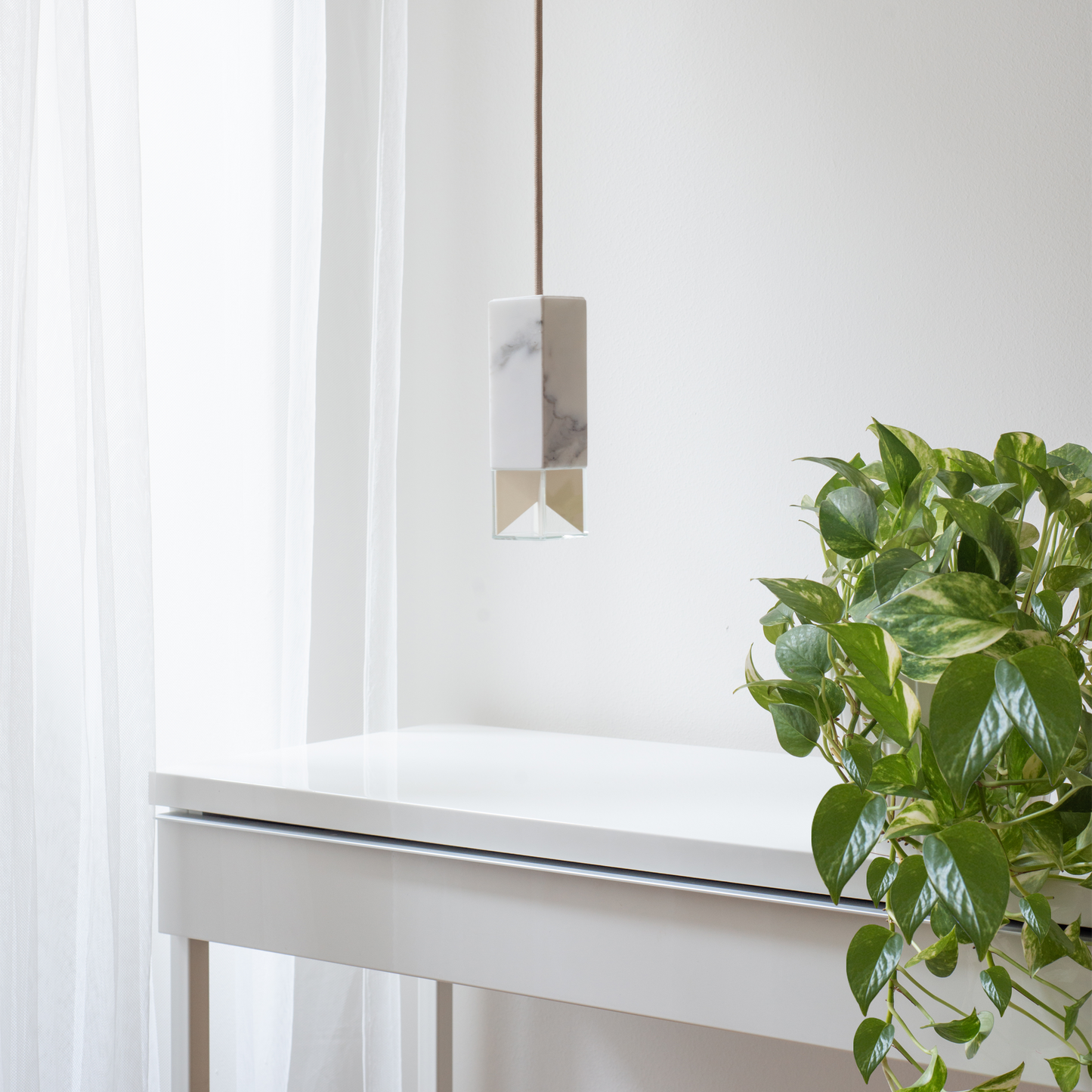 Lamp One Pendant Light / Marble, in living room setting.