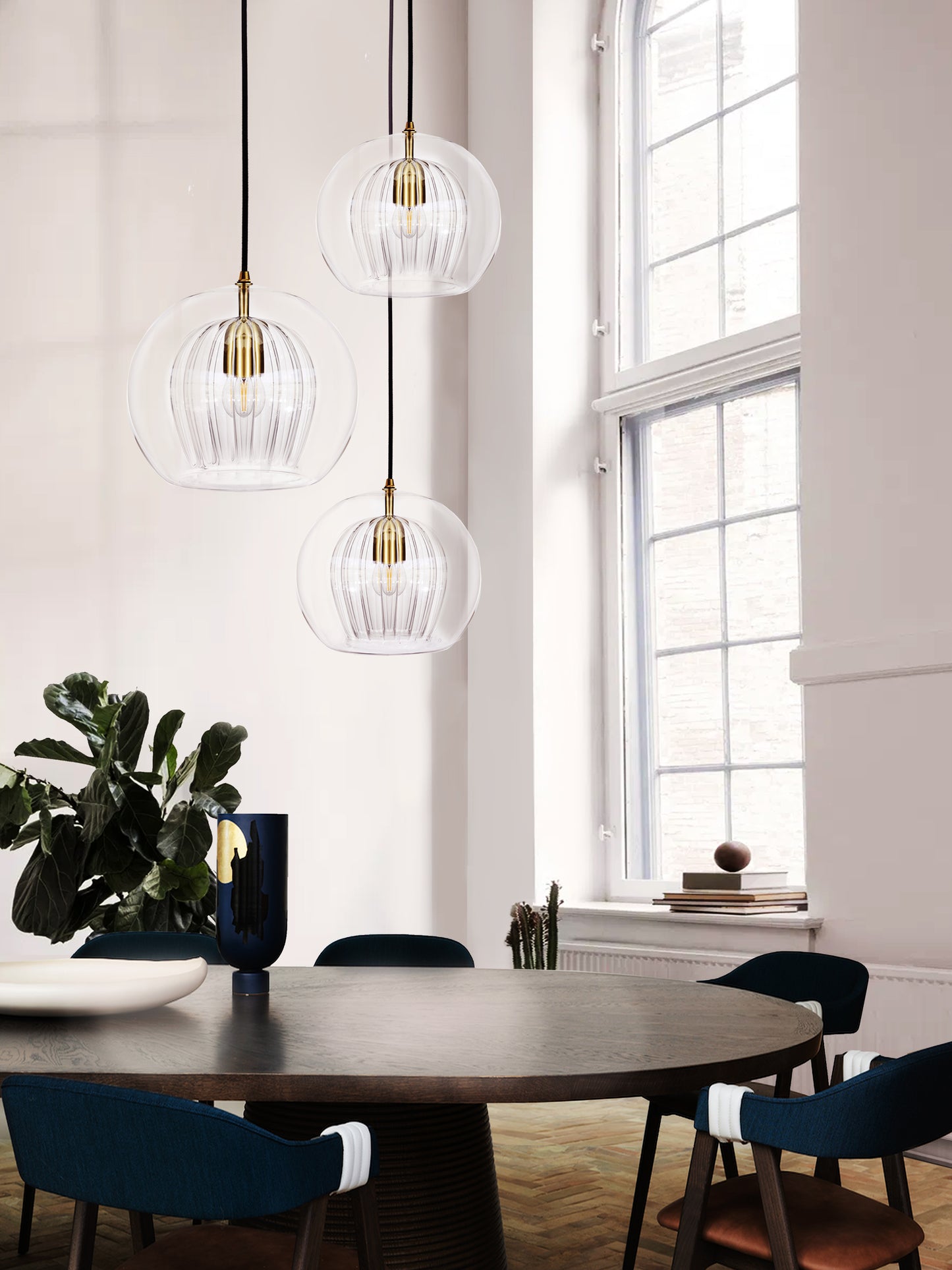 Pleated Crystal 3 Pendant Cluster Light smoked, hanging from ceiling above table.