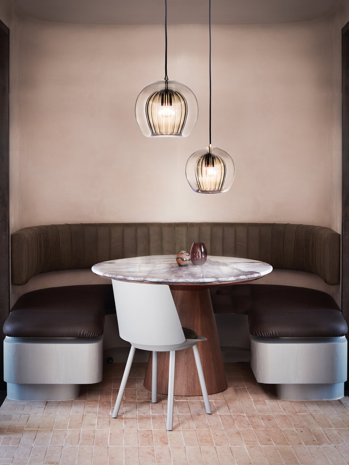 Pleated Crystal Pendant Light smoked, hanging from ceiling above table in setting.
