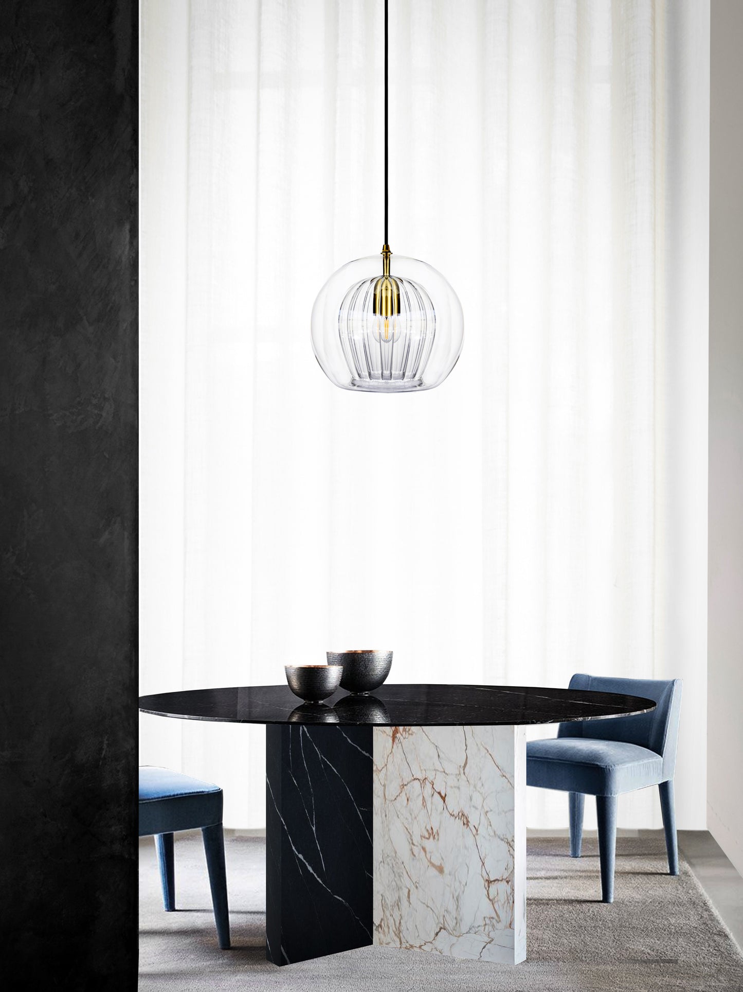Pleated Crystal Pendant Light clear, hanging from ceiling above table in setting.