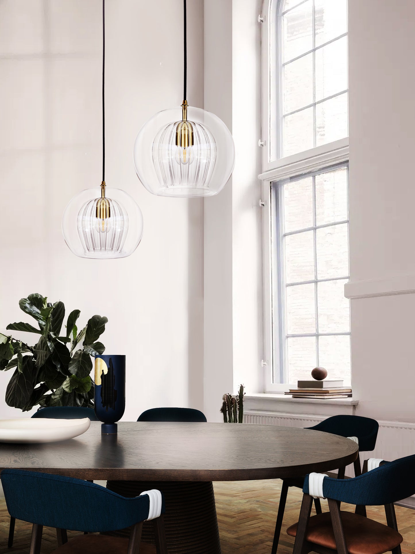 Pleated Crystal Pendant Light clear duo, hanging from ceiling above table in setting.