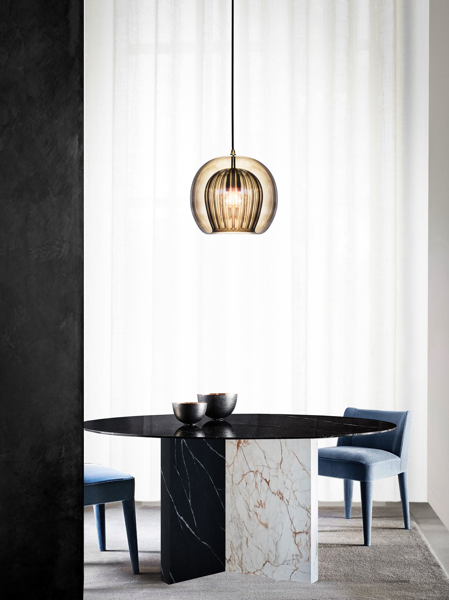 Pleated Crystal Pendant Light smoked, hanging from ceiling above table in setting.