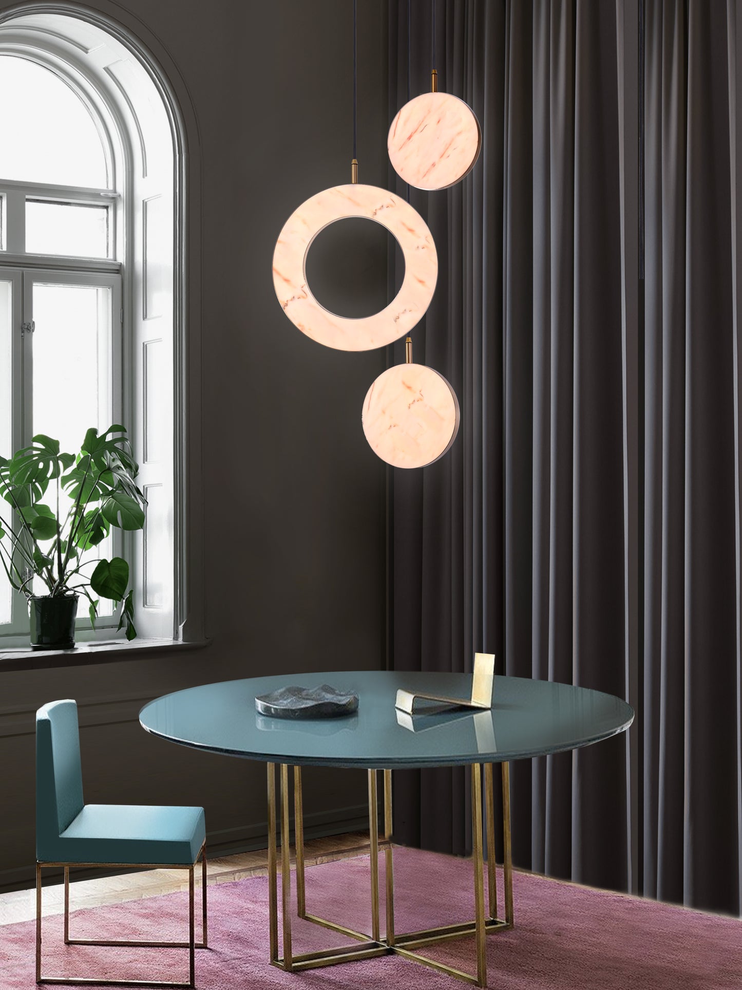 Rosa Ring 3 Cluster Light, hanging from ceiling above table in setting.