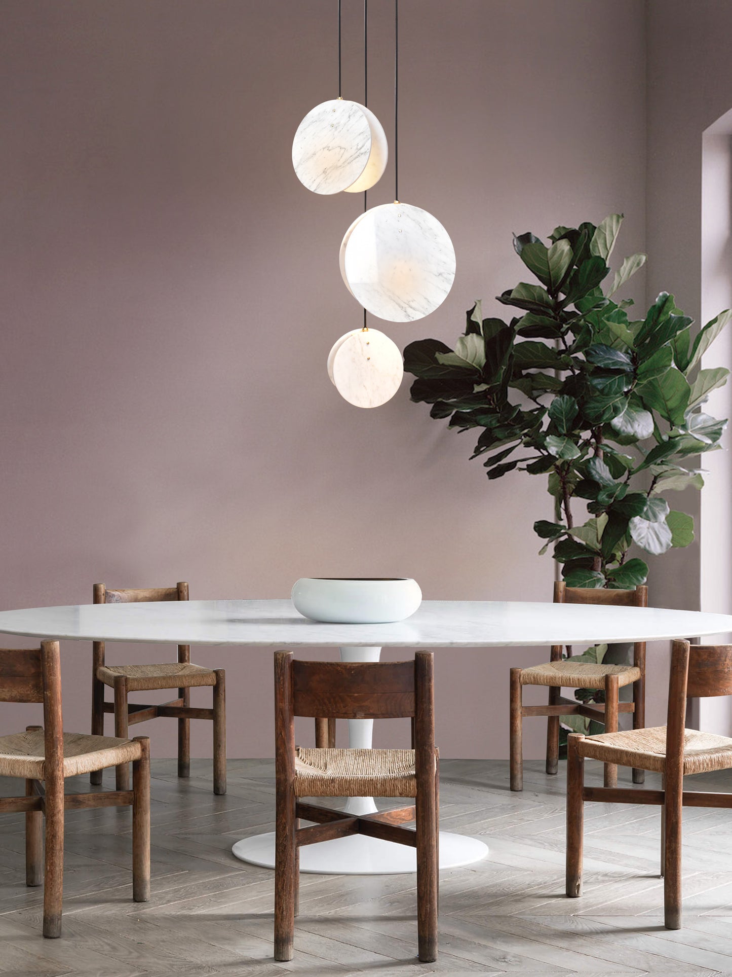 Shell 3 Light, hanging from ceiling in setting above table.
