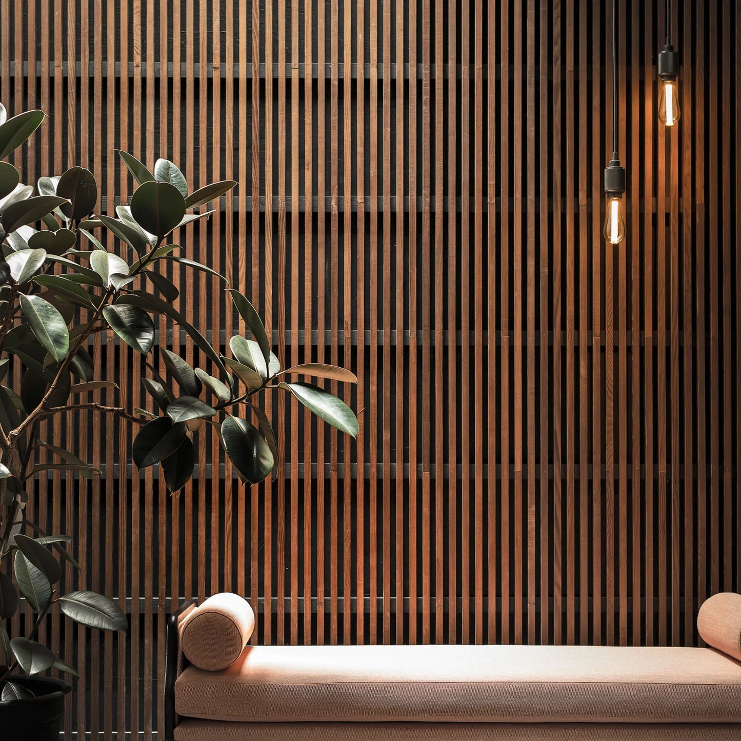 Heavy Metal Pendant light / Cross smoked bronze, on in setting above seat.
