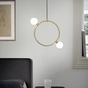 Drops Pendant Light, hanging from ceiling above bedside table in setting.