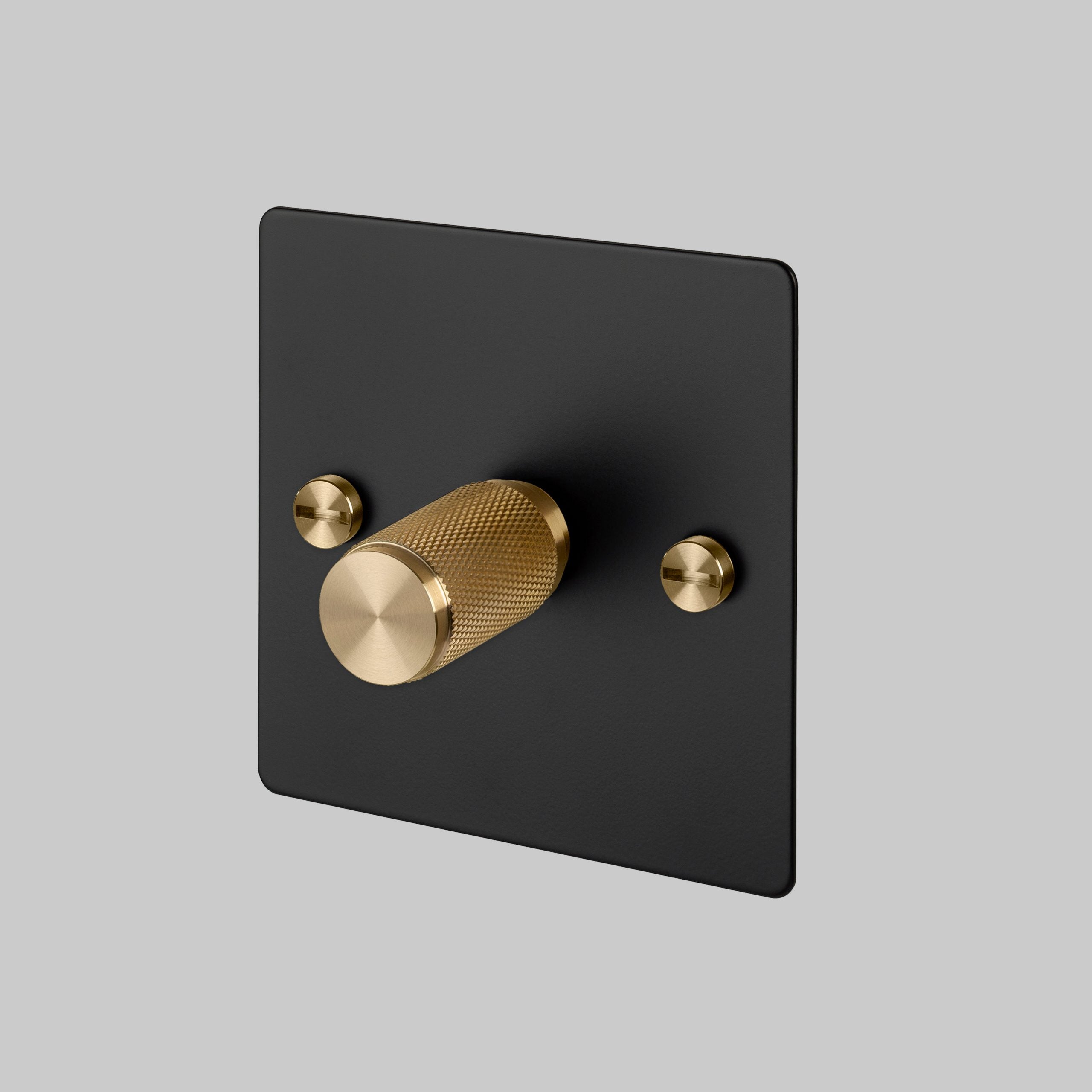 1G Dimmer/ 100W/ Black with Brass details, angled view.