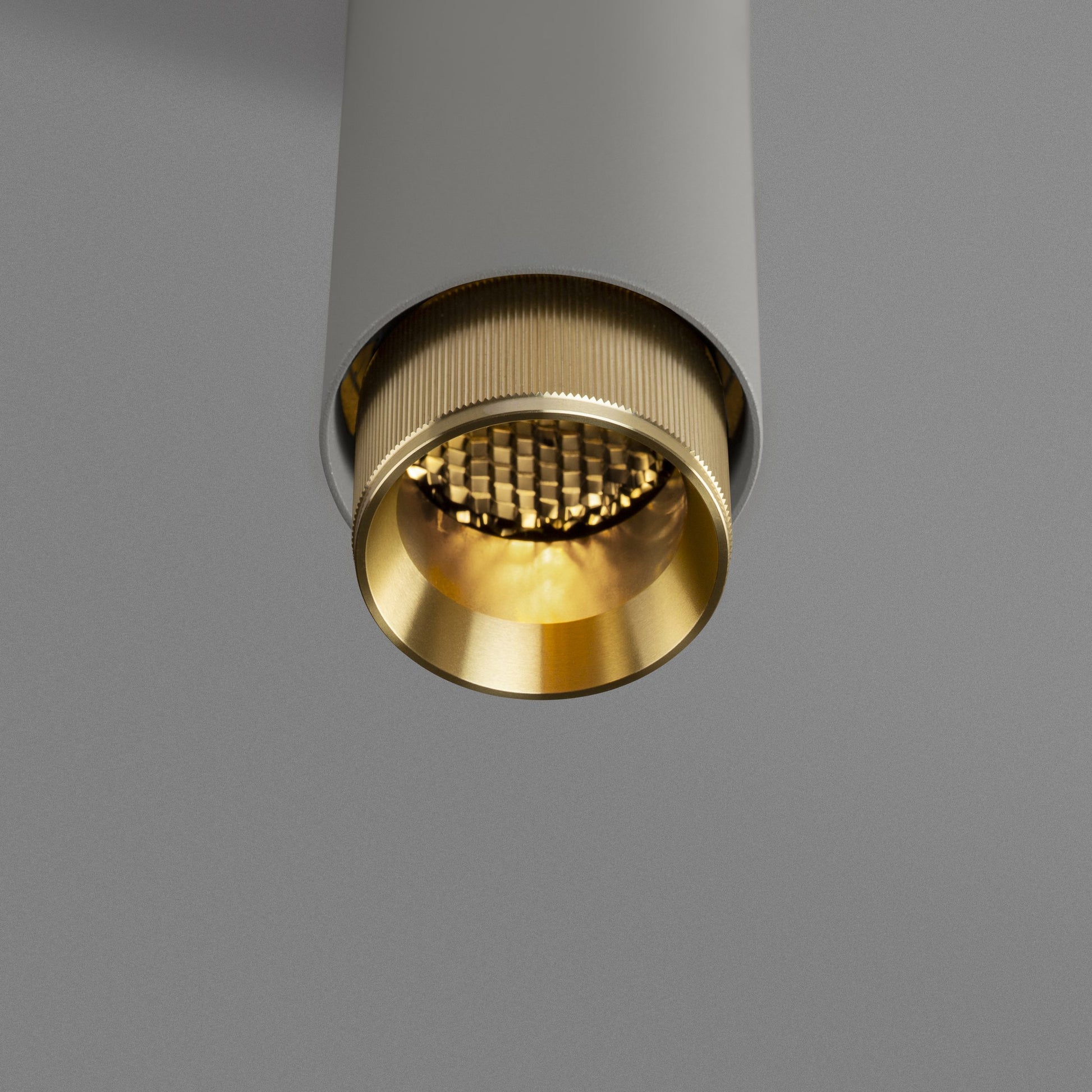 Exhaust Pendant Light / Linear / Stone Brass, detailed close up view from upneath of knurling and light.