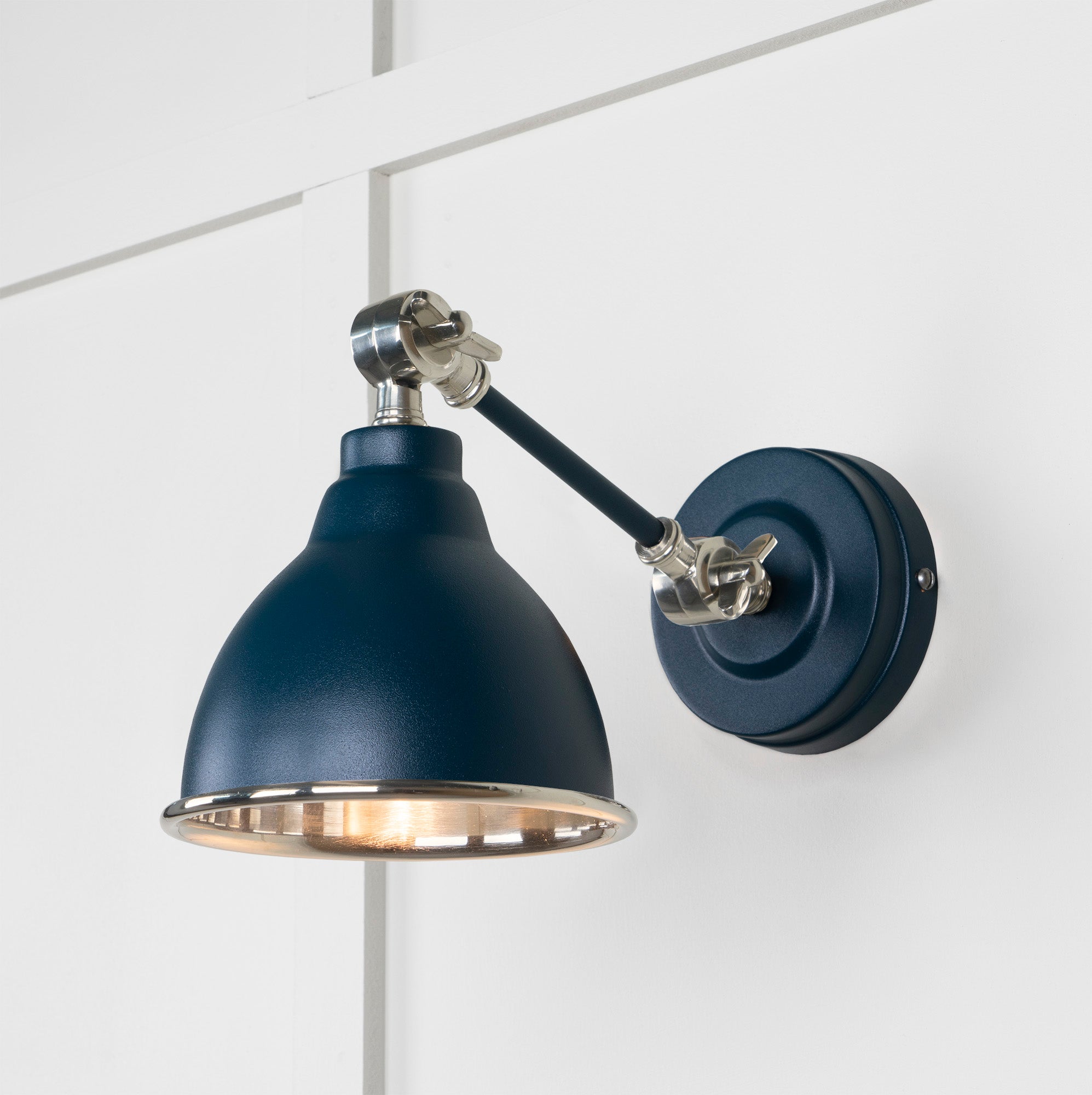 Smooth Nickel Brindley Wall Light Dusk, Front Side with light on.