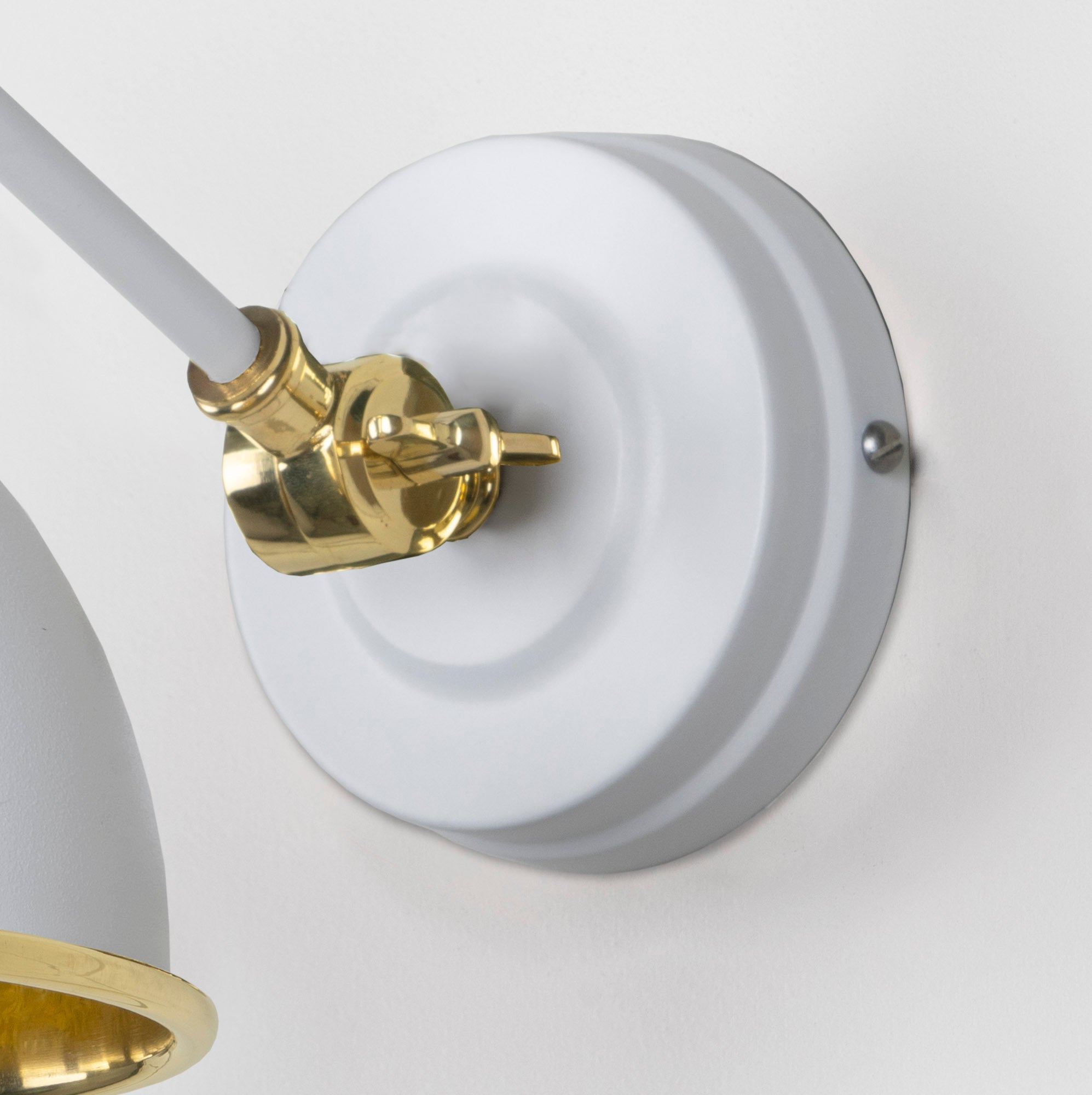 Smooth Brass Brindley Wall Light Flock, close up view of fitting and cable.