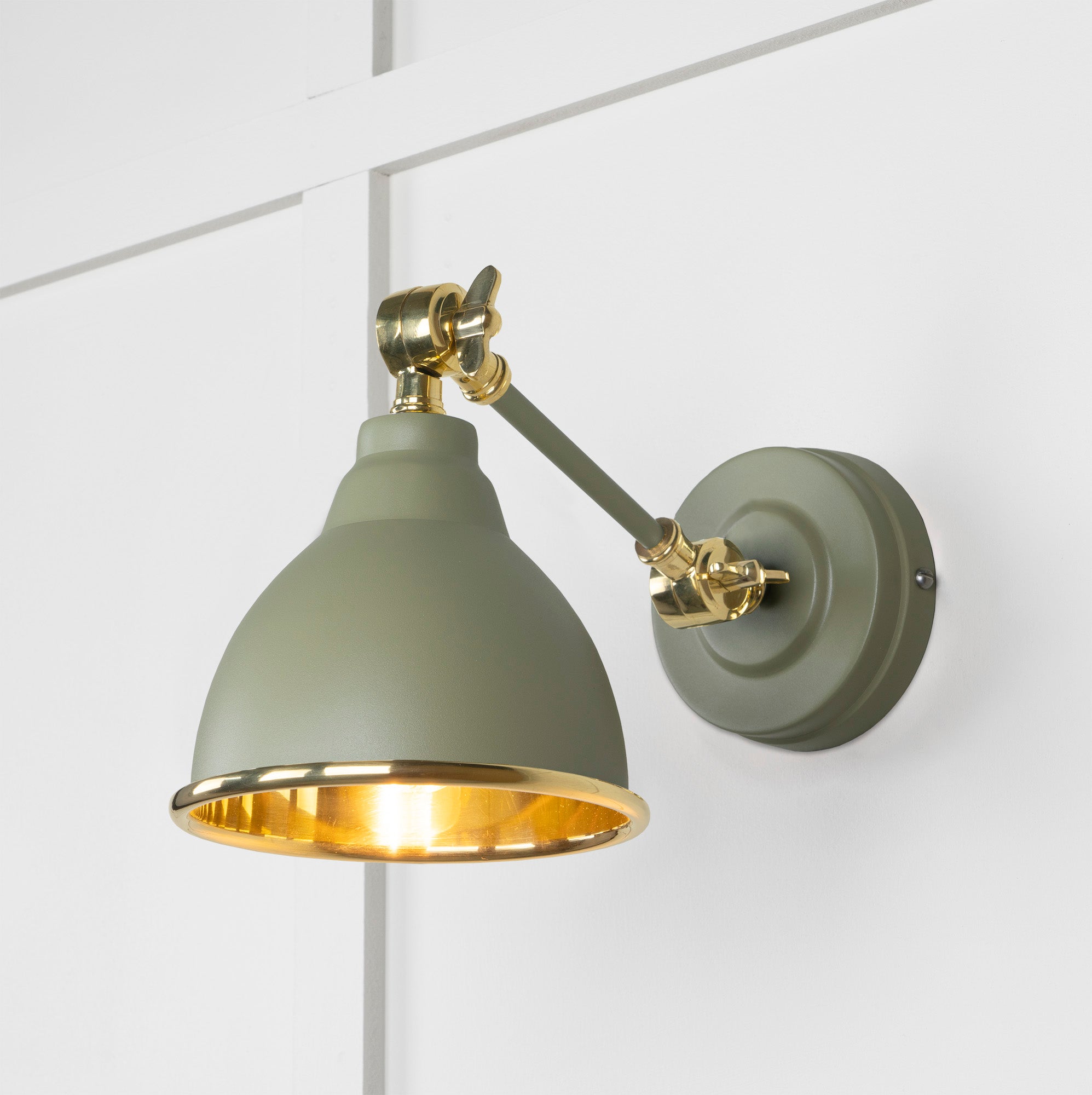 Smooth Brass Brindley Wall Light Tump, Front Side with light on.