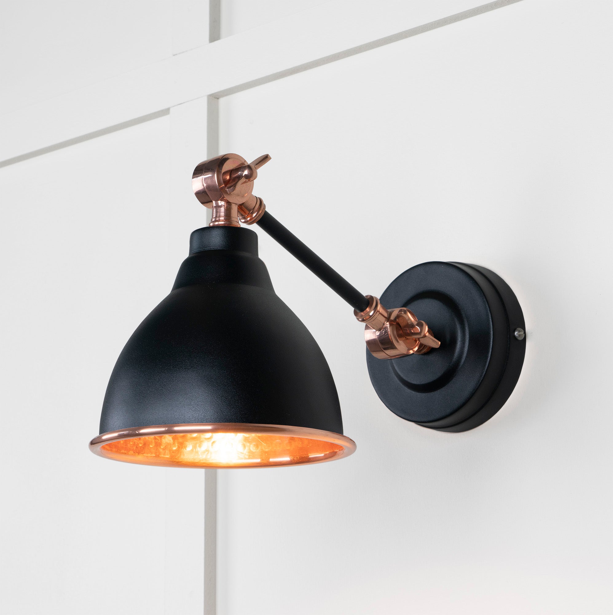 Hammered Copper Brindley Wall Light Elan Black, Front Side with light on.