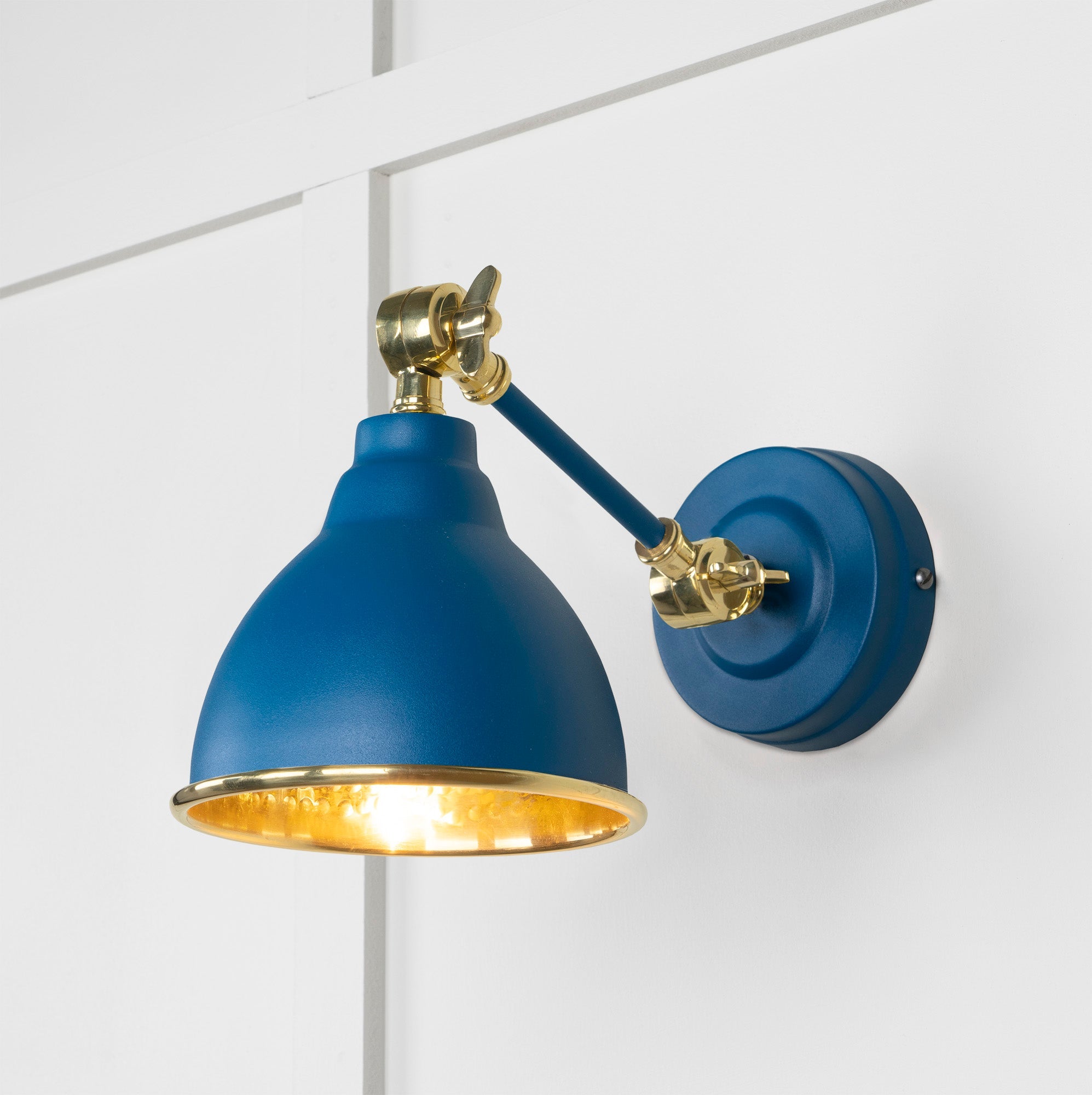 Hammered Brass Brindley Wall Light Upstream, Front Side with light on.
