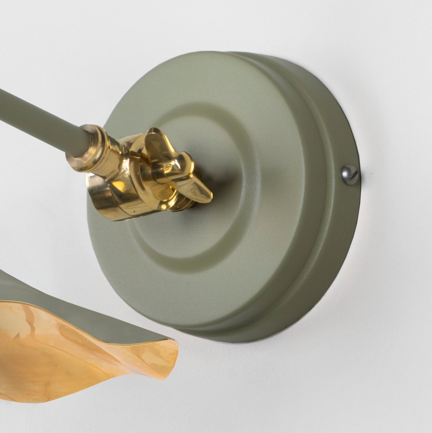 Smooth Brass Flora Wall Light Tump, close up view of fitting and cable.