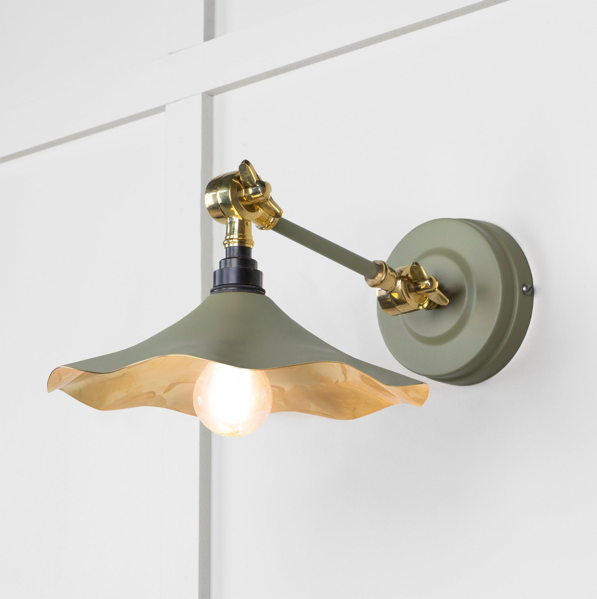 Smooth Brass Flora Wall Light Tump, Front Side with light on.