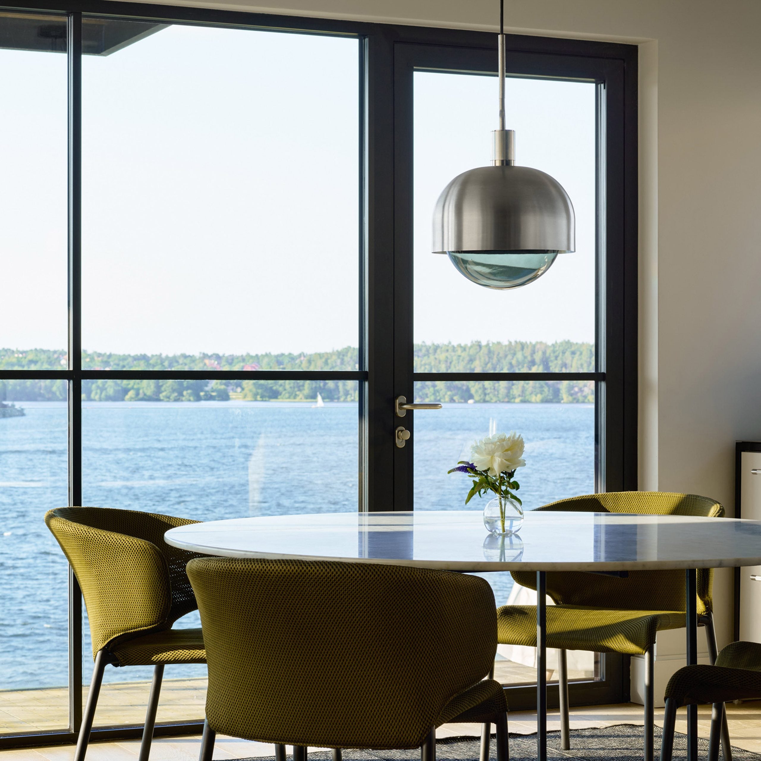 Forked Pendant Light / Shade / Globe / Smoked / Large Steel, hanging above dining table in setting.