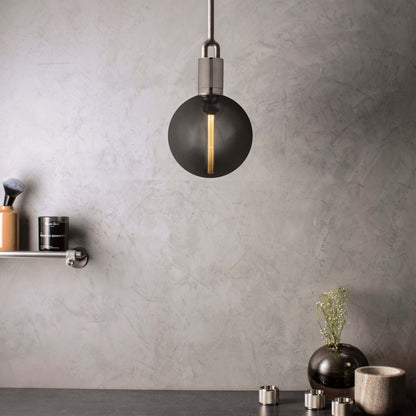 Forked Pendant Light / Globe / Smoked / Large steel, front view with background.