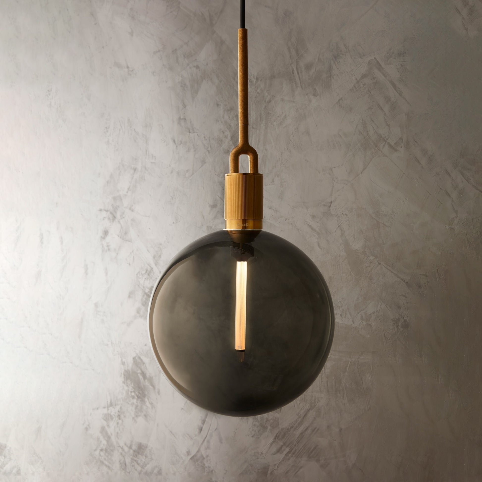 Forked Pendant Light / Globe / Smoked / Large Brass, close up view with background.