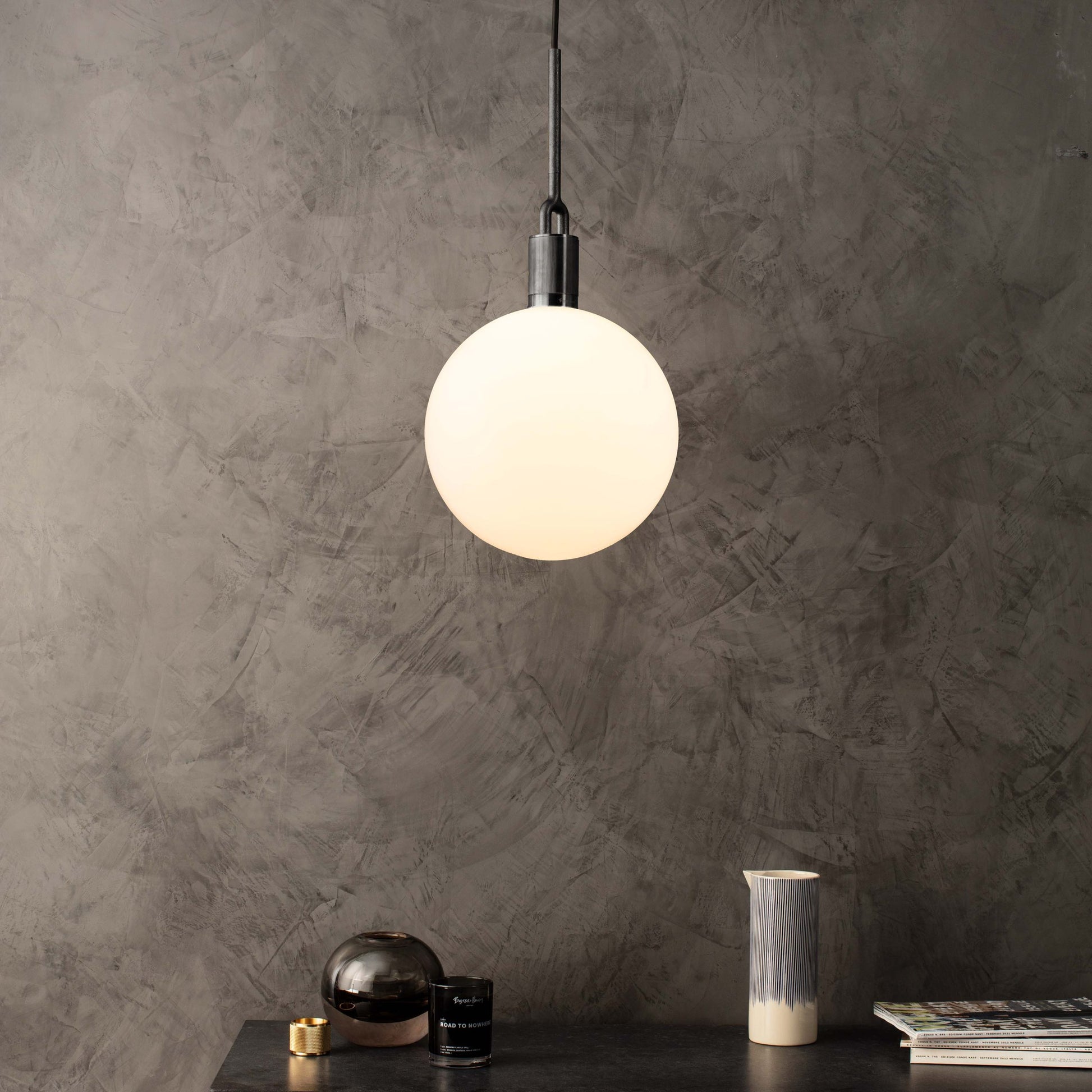 Forked pendant Light / Globe / Opal / Medium gun metal, front view in setting.