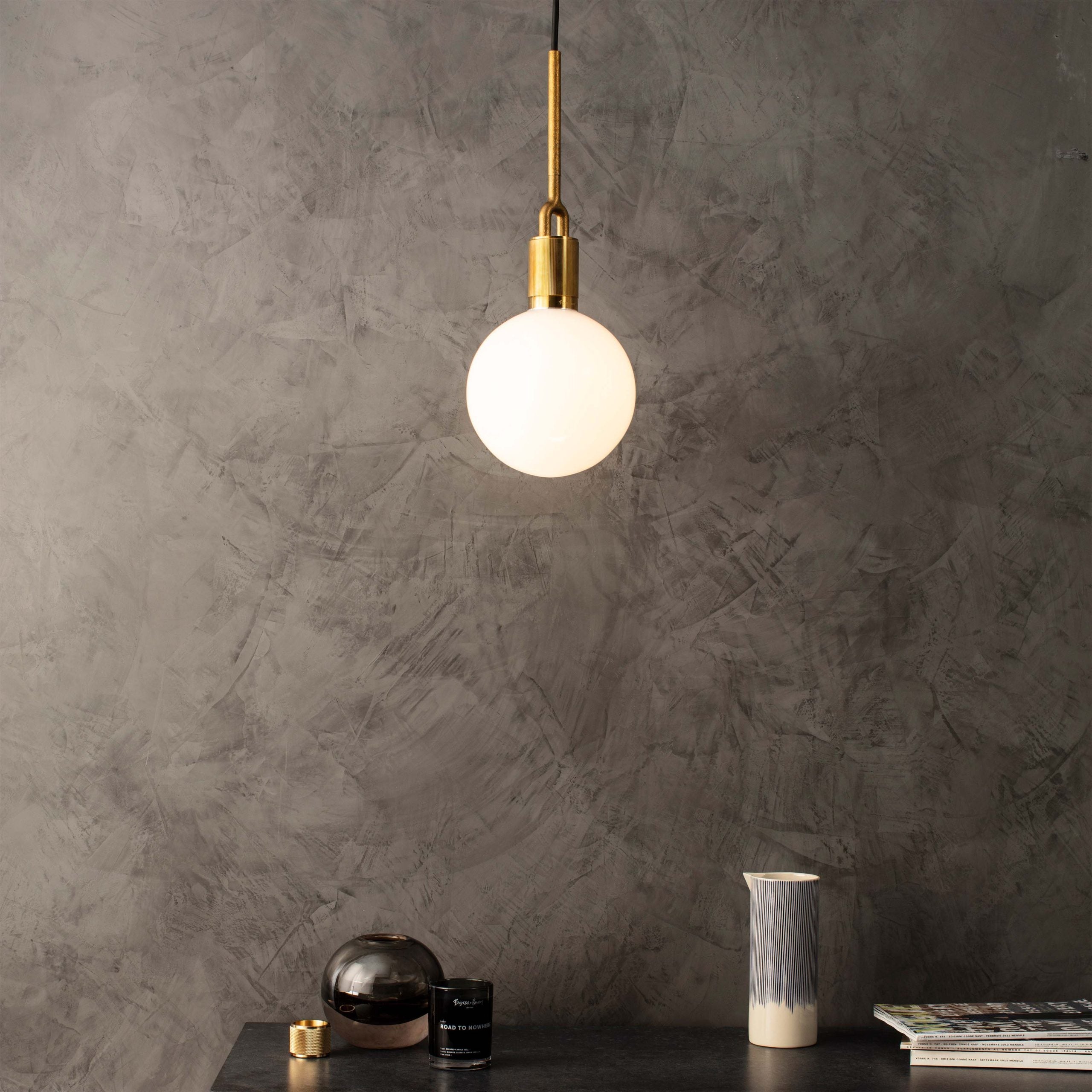 Forked pendant Light / Globe / Opal / Medium brass, front view in setting.