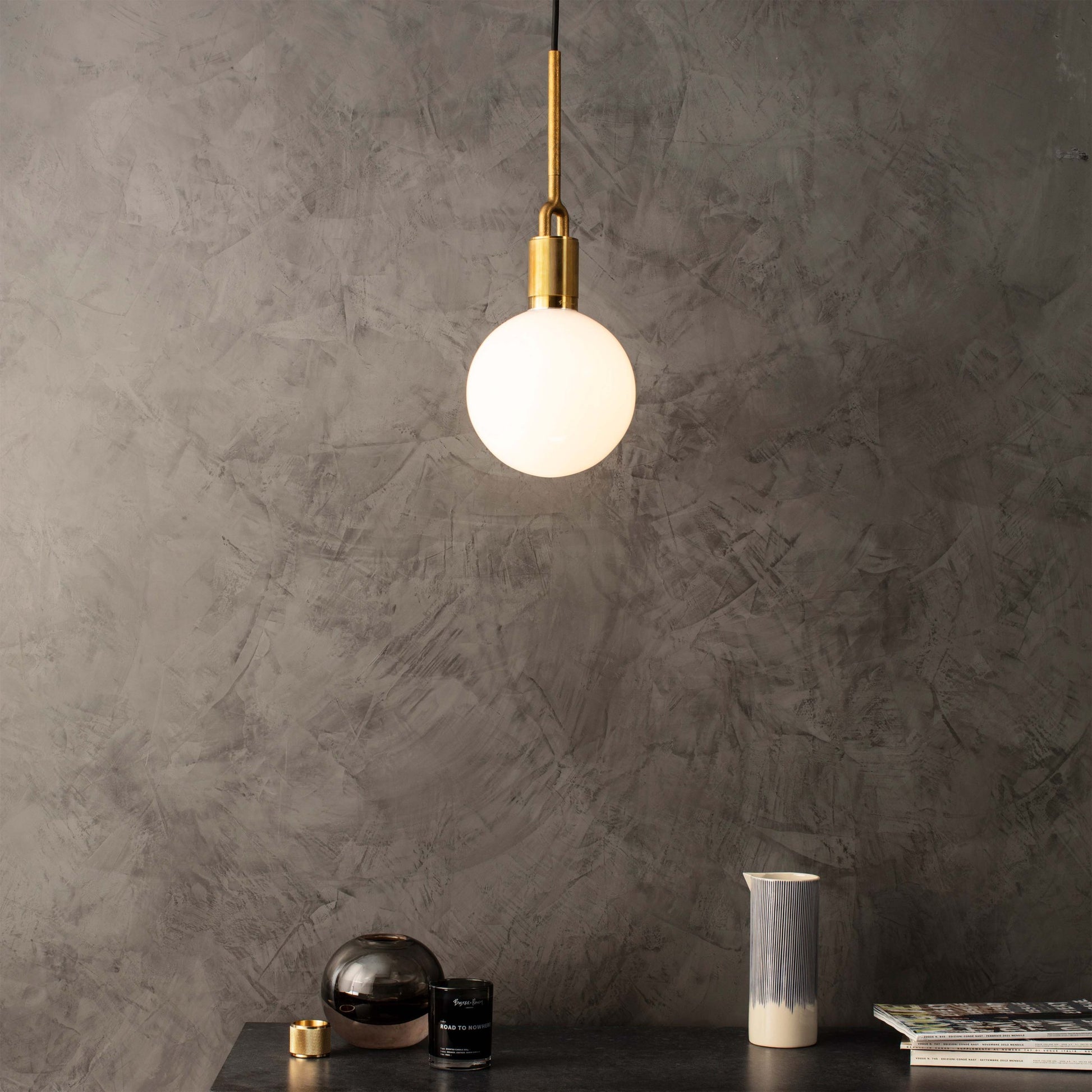 Forked pendant Light / Globe / Opal / Medium brass, front view in setting.