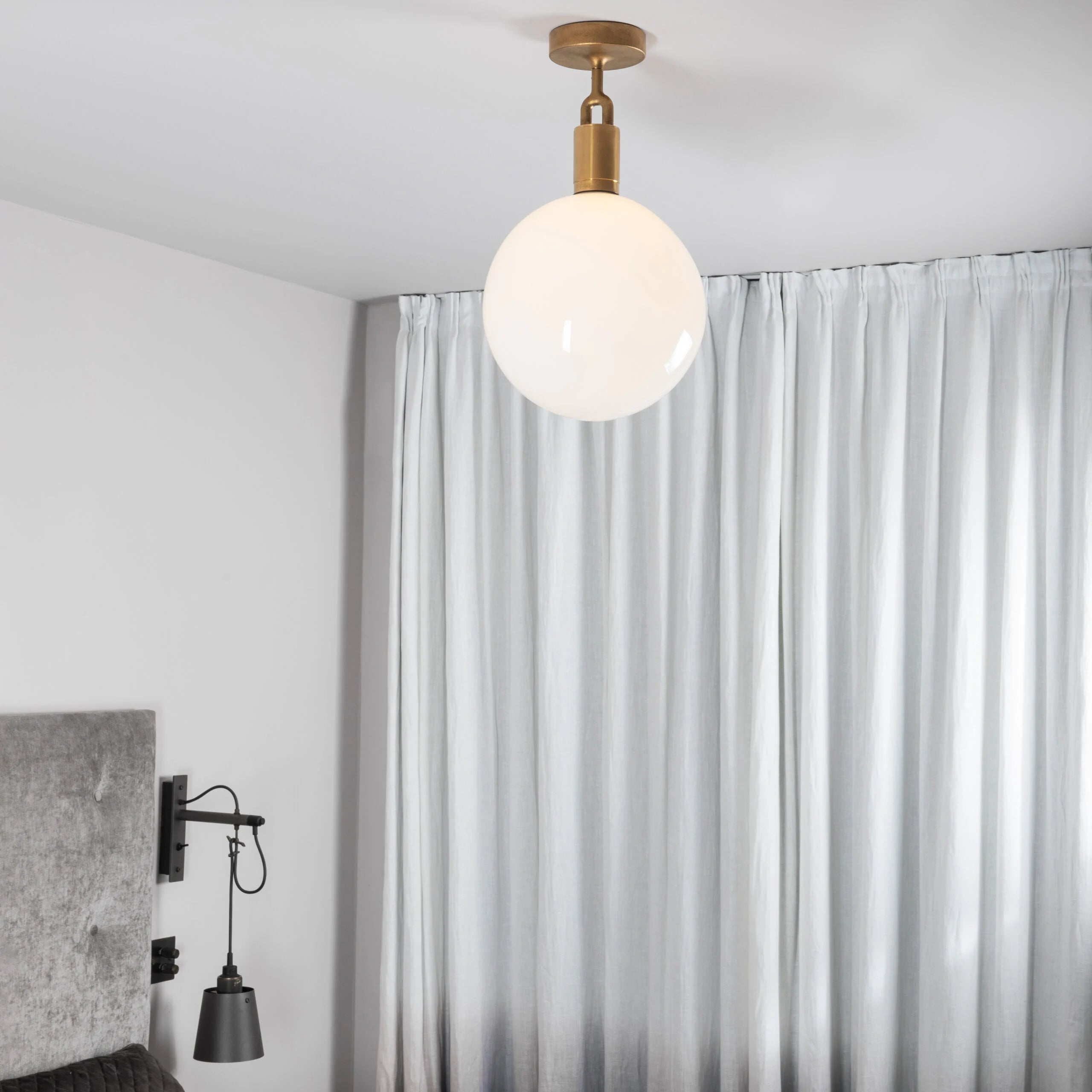 Forked Ceiling Light / Globe / Opal / Large Brass, on ceiling in bedroom setting.