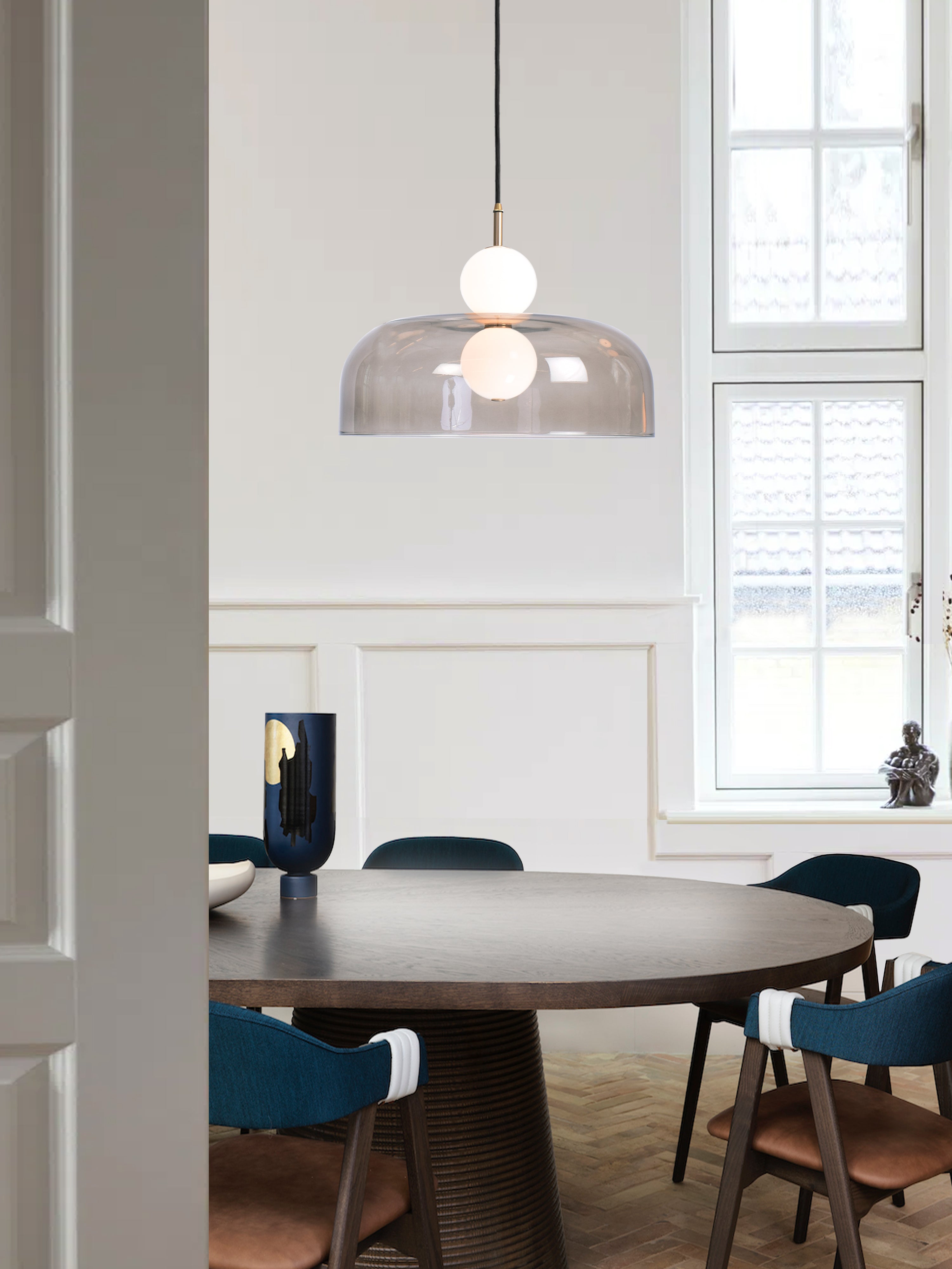 Echo Shade Pendant Light, hanging from ceiling above table in setting.