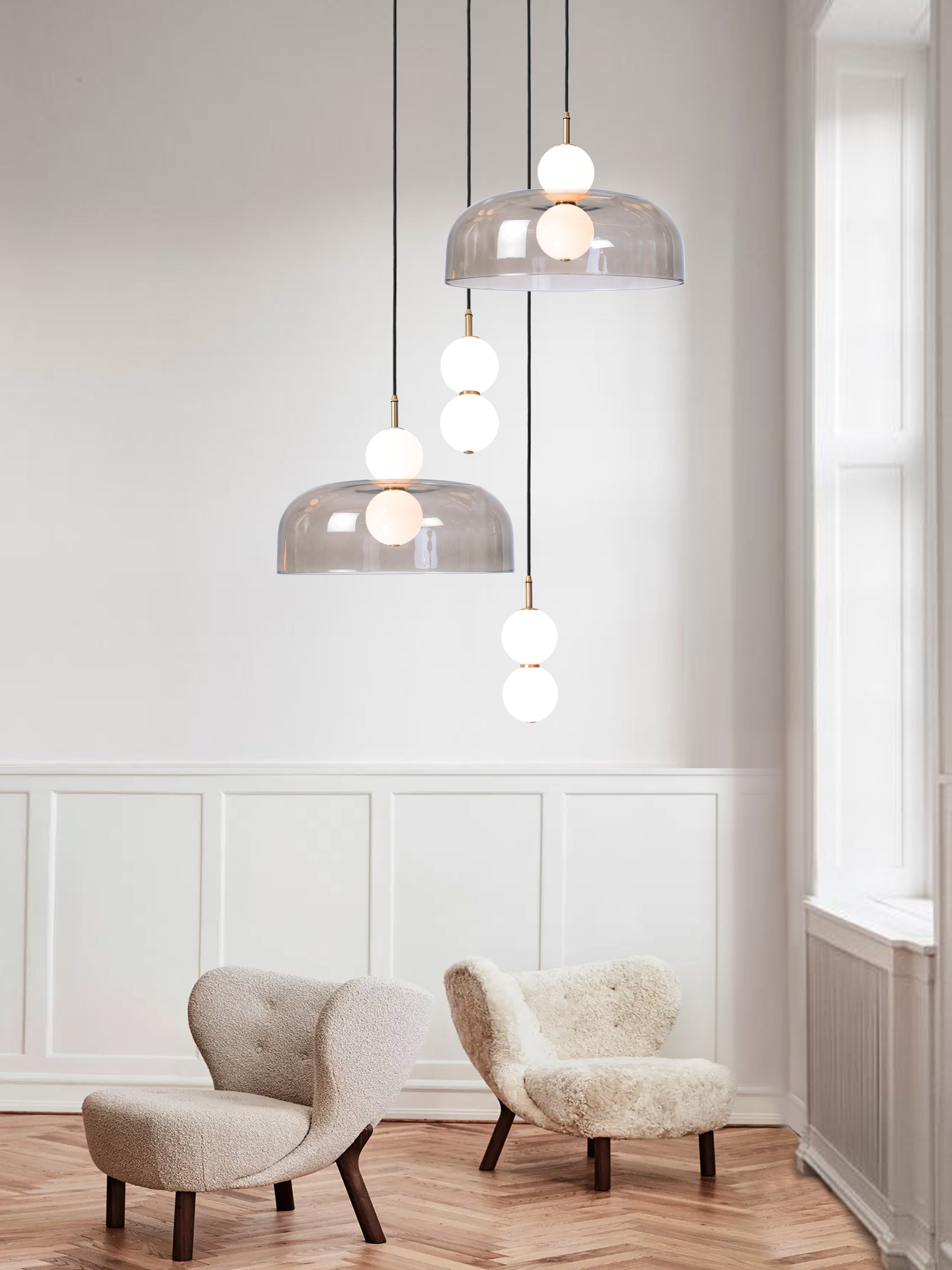 Echo 4 Shade Cluster Light, hanging from ceiling above chairs in setting.
