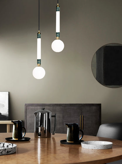 Greenstone Small Pendant Light, hanging from ceiling above table in setting.