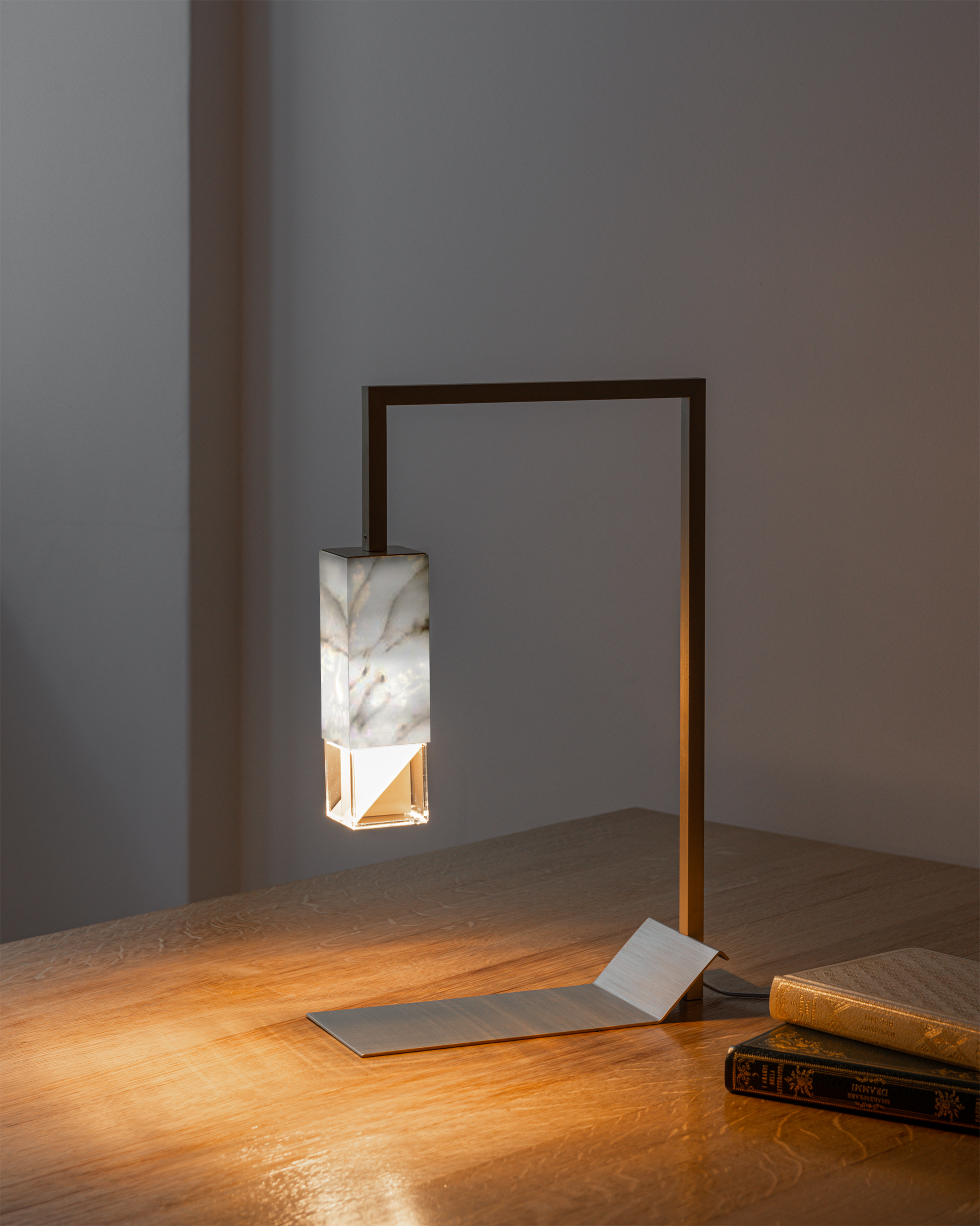 Lamp Two Table Light / Marble, on table in setting, switched on.