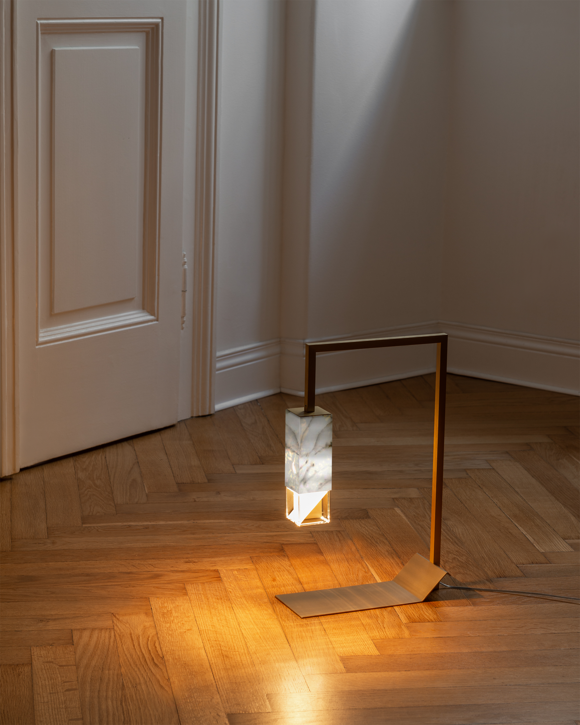 Lamp Two Table Light / Marble, on floor in setting.