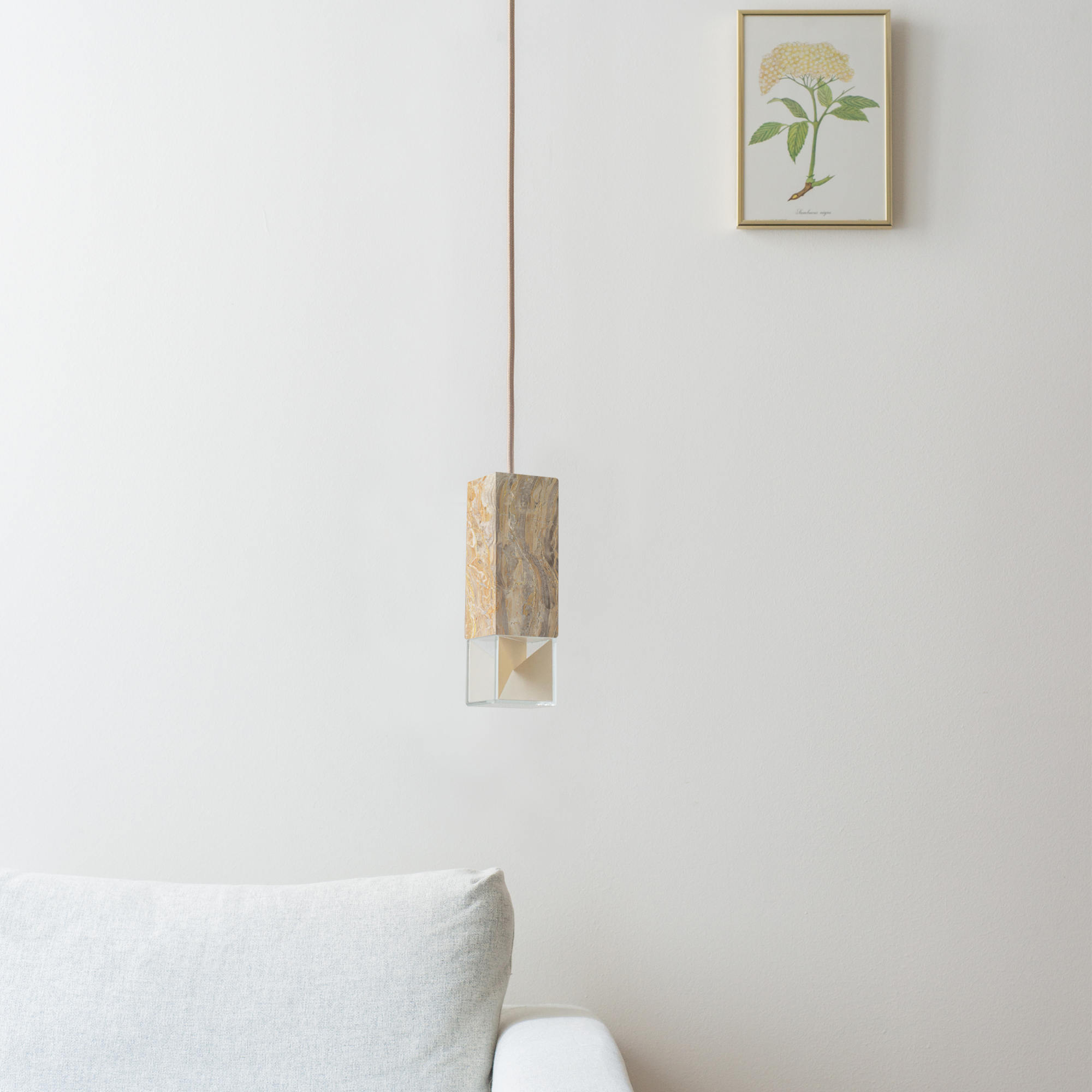 Lamp One Pendant Light / Marble, hanging from ceiling in living room setting.