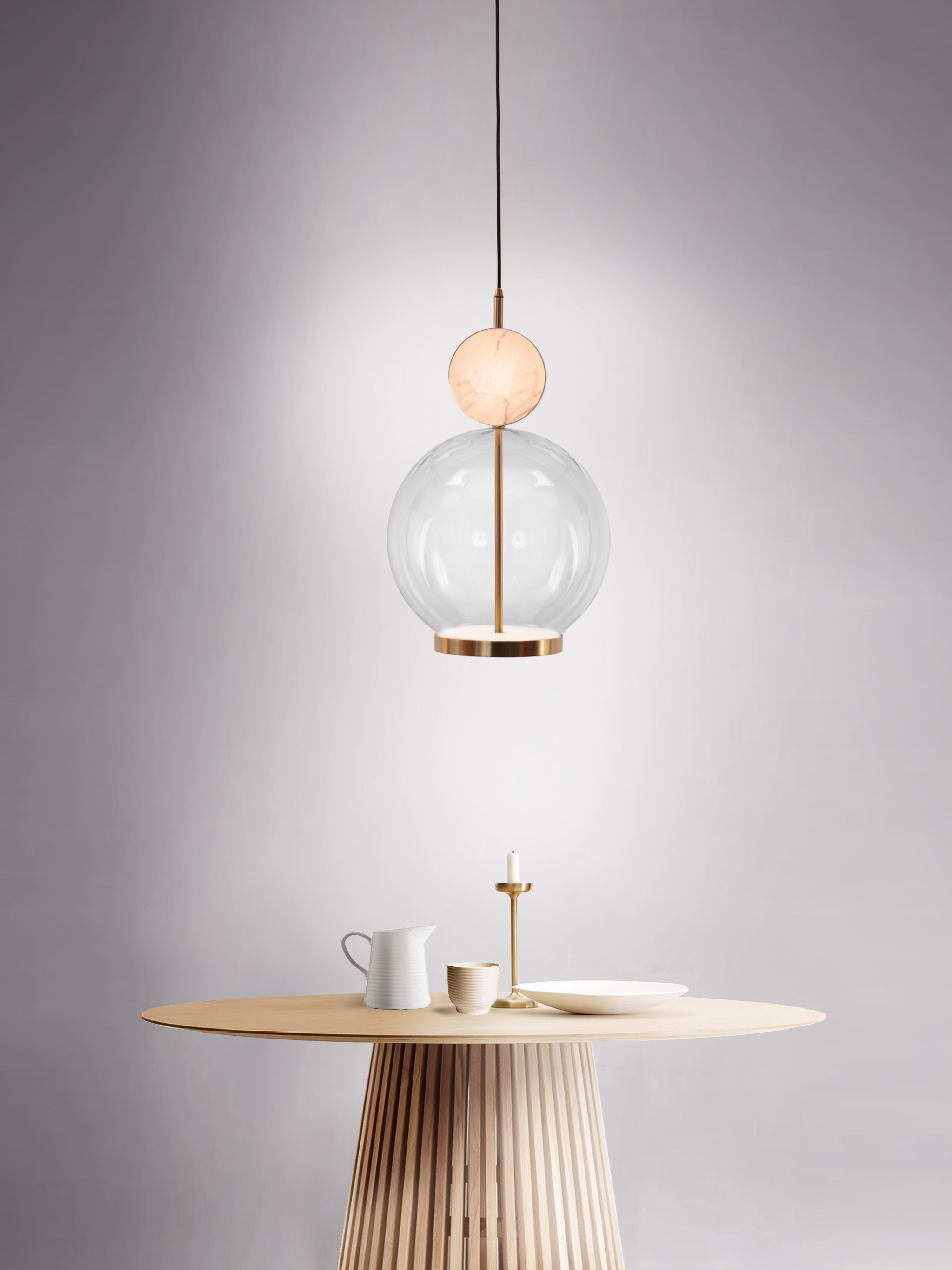 Rosa Pendant Light, hanging from ceiling above table.