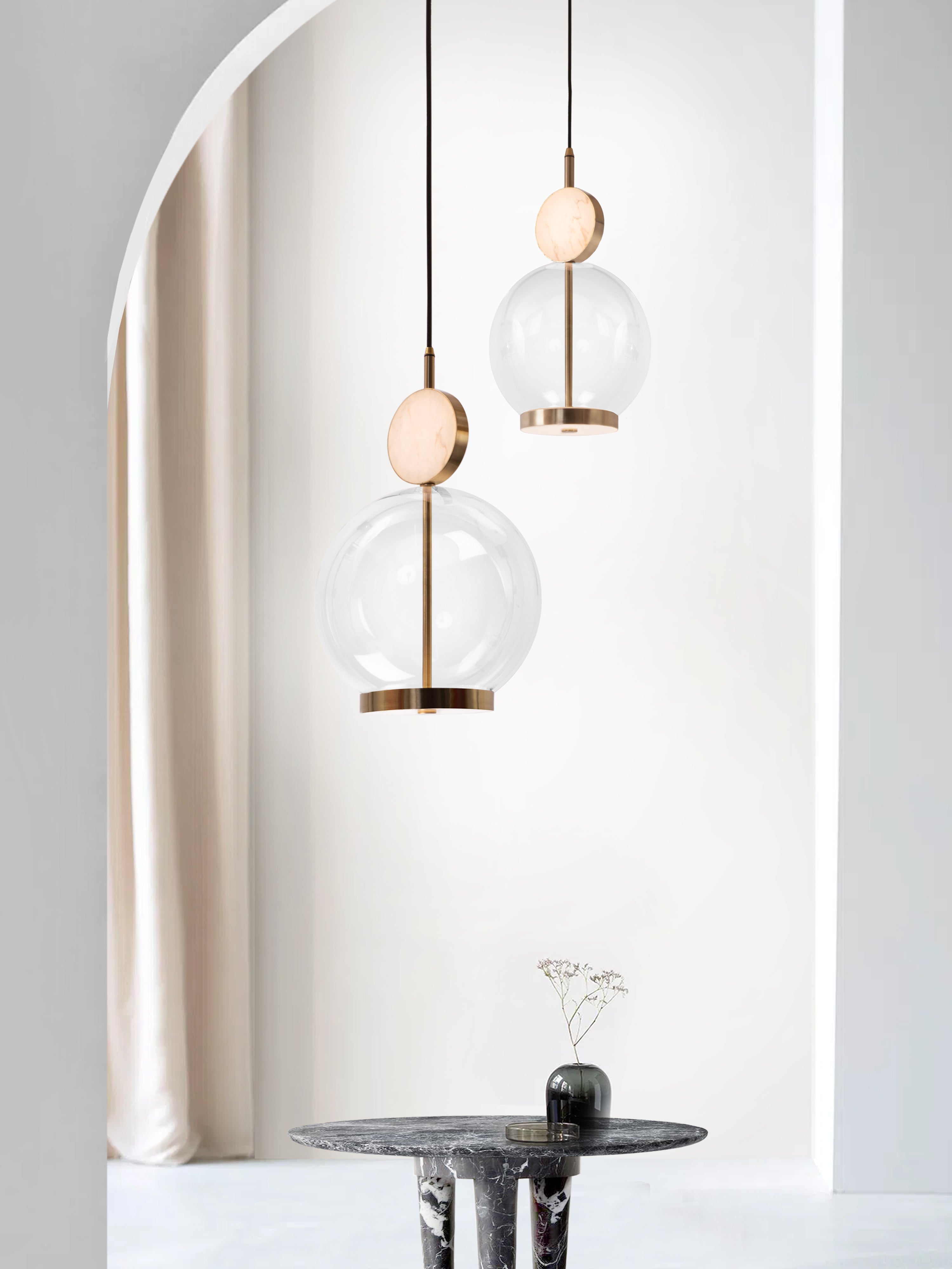 Rosa Pendant Light, hanging from ceiling above table.