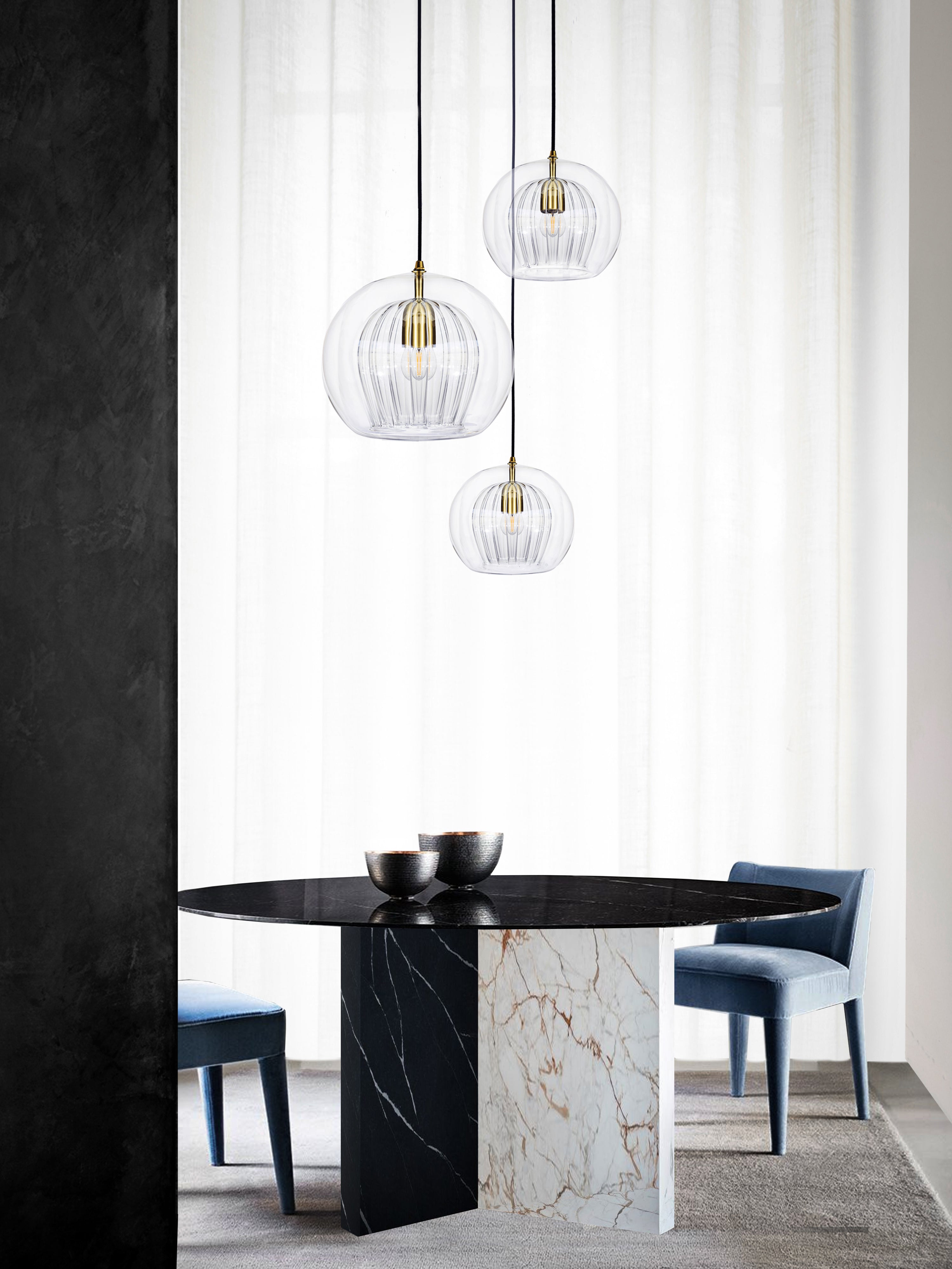 Pleated Crystal 3 Pendant Cluster Light clear, hanging from ceiling above table.