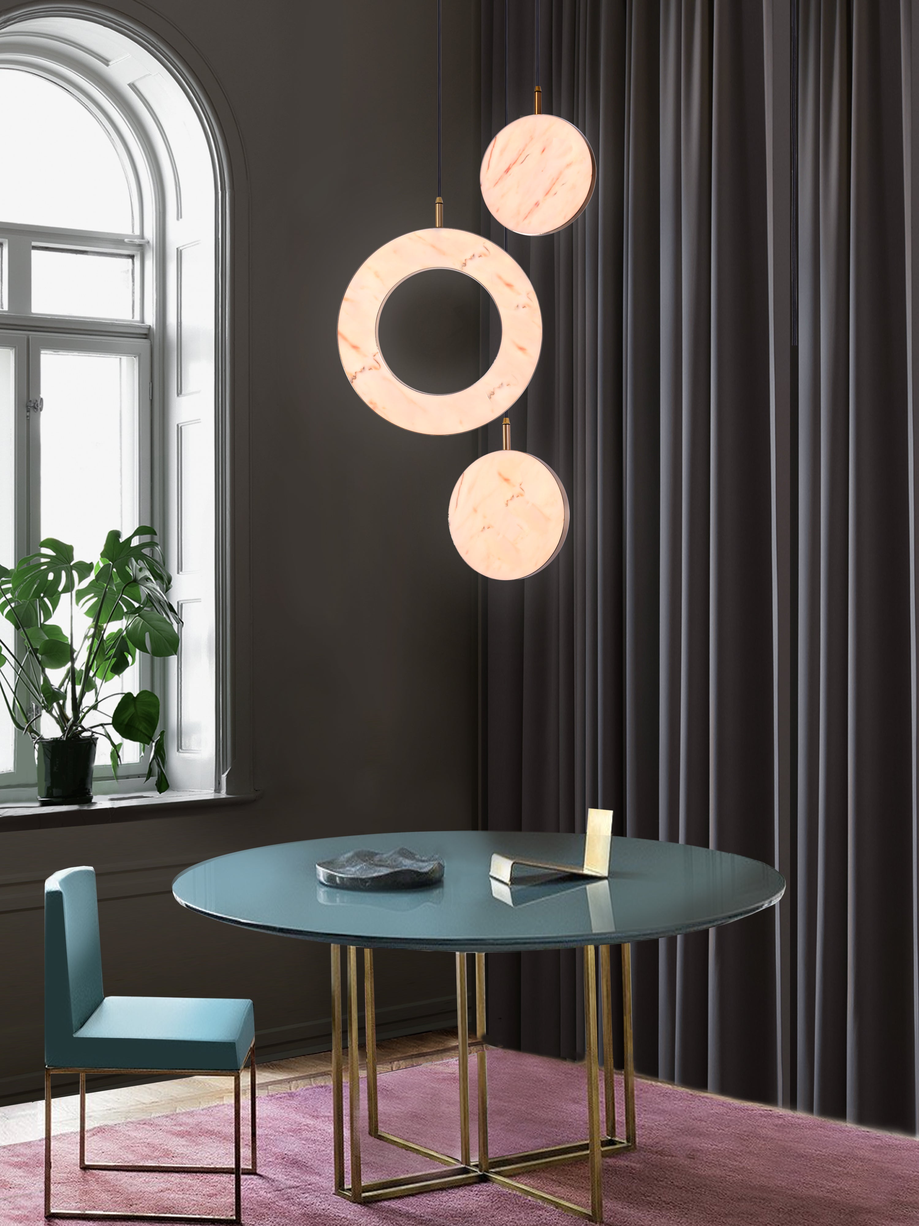 Rosa Ring 3 Cluster Light, hanging from ceiling above table in setting.