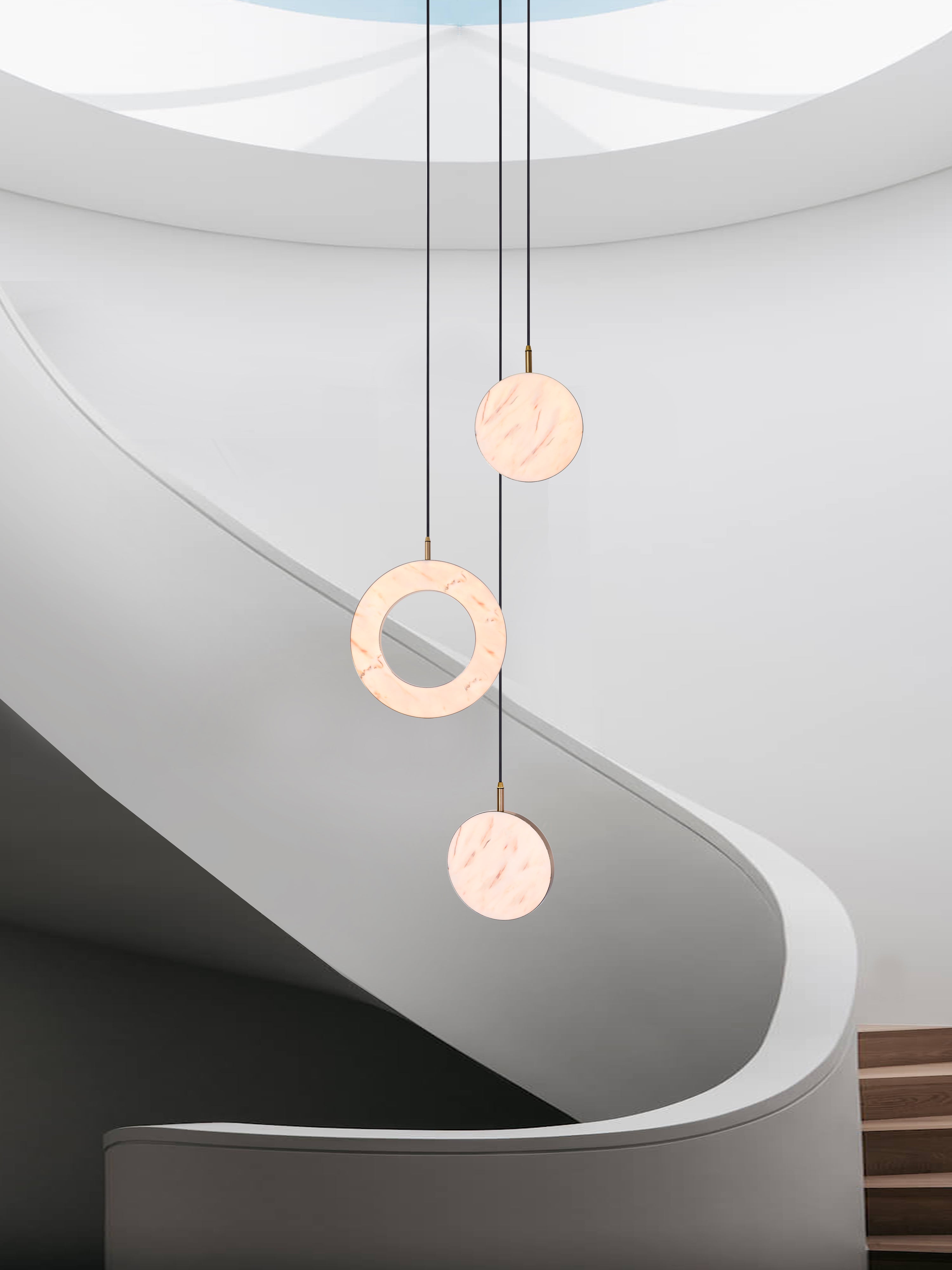 Rosa Ring 3 Cluster Light, hanging from ceiling above stairs  in setting.