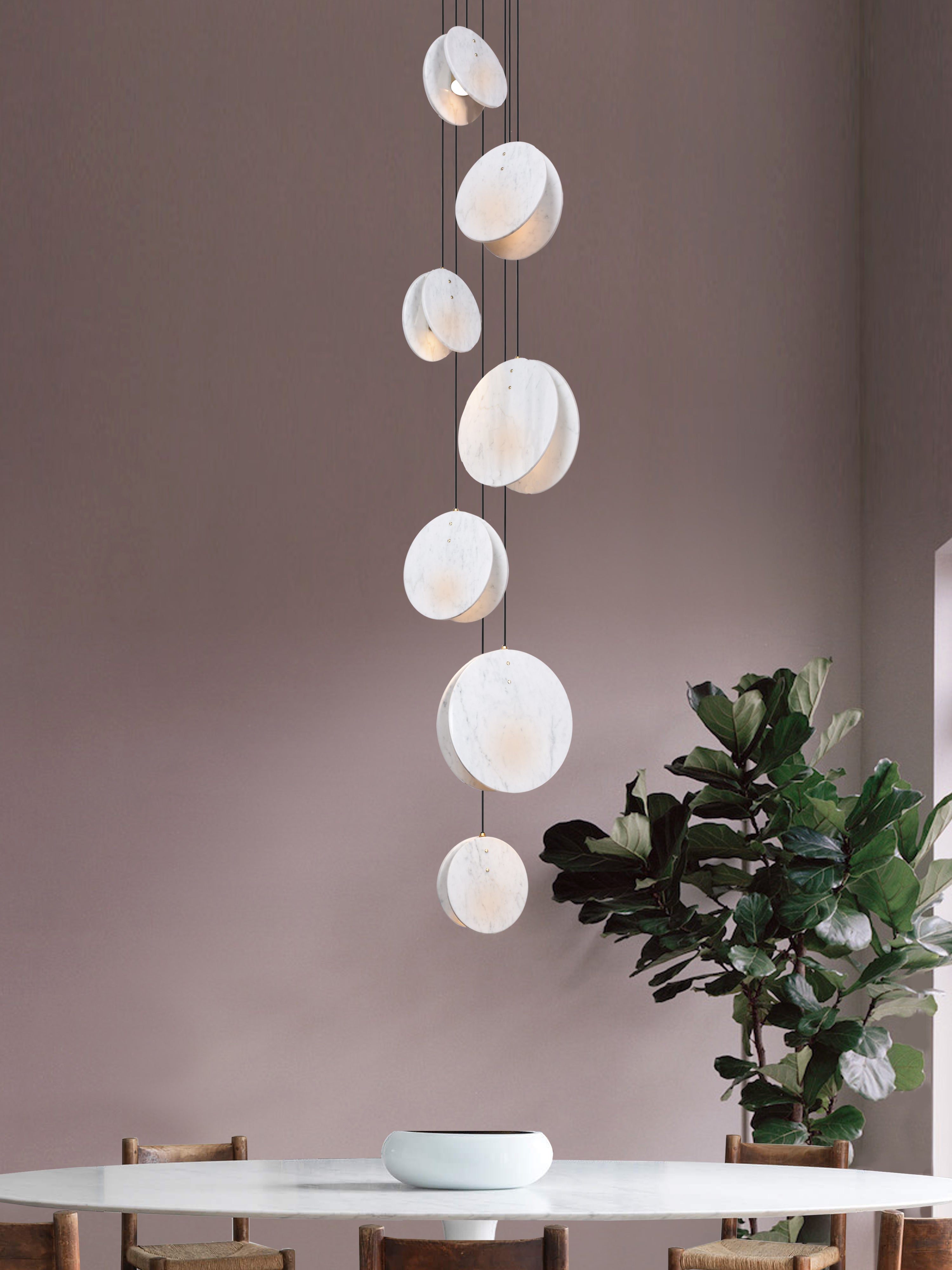 Shell 7 Light, hanging from ceiling above table in setting.